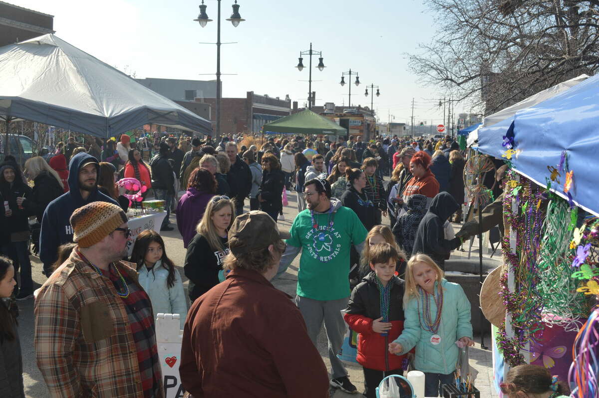 Crowds fill Niedringhaus Avenue in Granite City where 25 vendors set up as part of the community's inaugural Mardi Gras celebration. Other events included a Cajun cookoff and shuttle buses taking guests to 22 bars.