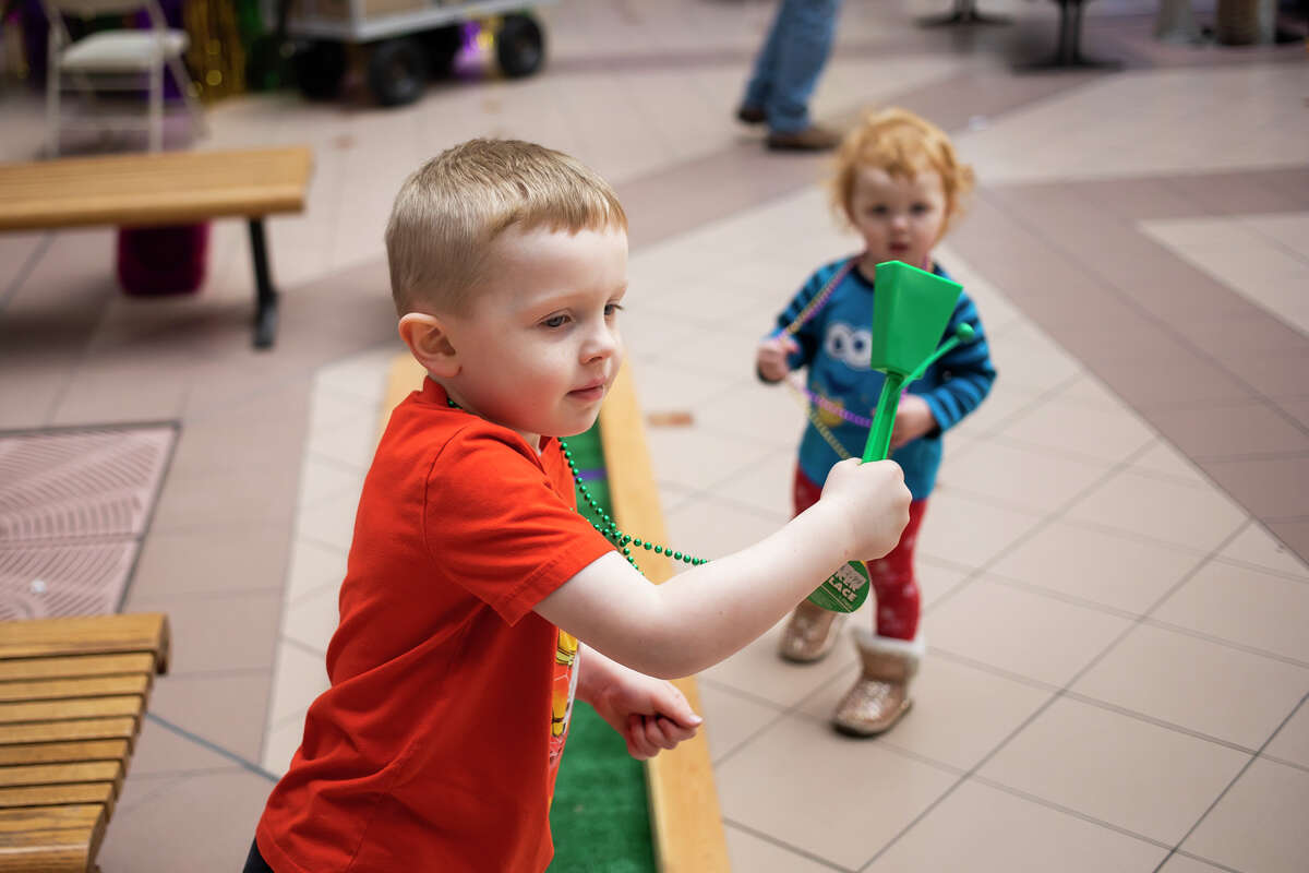 Joel Paytas, 5, and his sister, Beatrix Paytas, 2, play with noisemakers during the Relay for Life kickoff party Saturday, Feb. 26, 2022 at the Midland Mall.