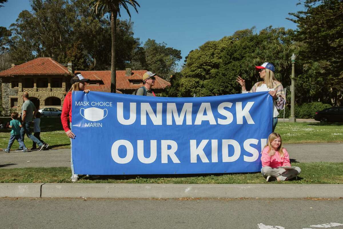 Brooklyn(left) Chelsea(right) hold a sign for the Mask Choice rally in San Francisco’s Golden Gate Park on Feb. 27, 2022. Their standpoint is that parents, not school administrators should decide if face masks are appropriate in San Francisco Schools.
