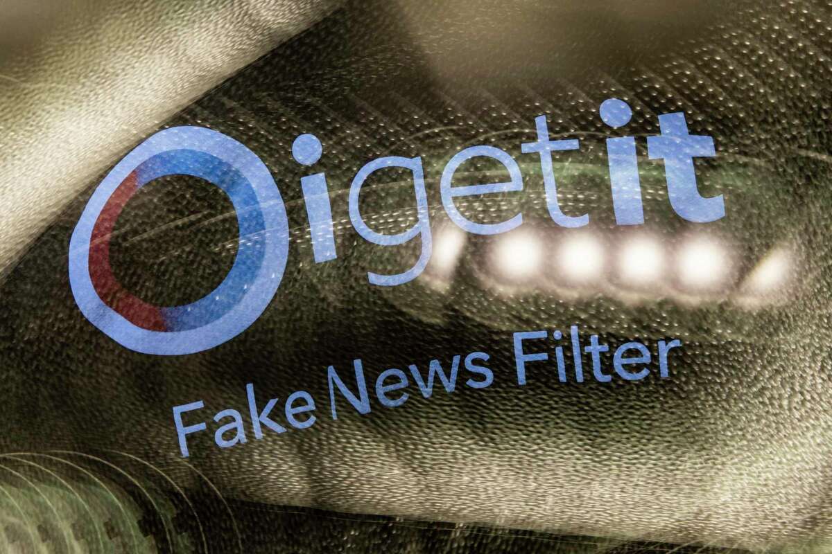 A sweatshirt with Oigetit Fake News Filter’s logo.