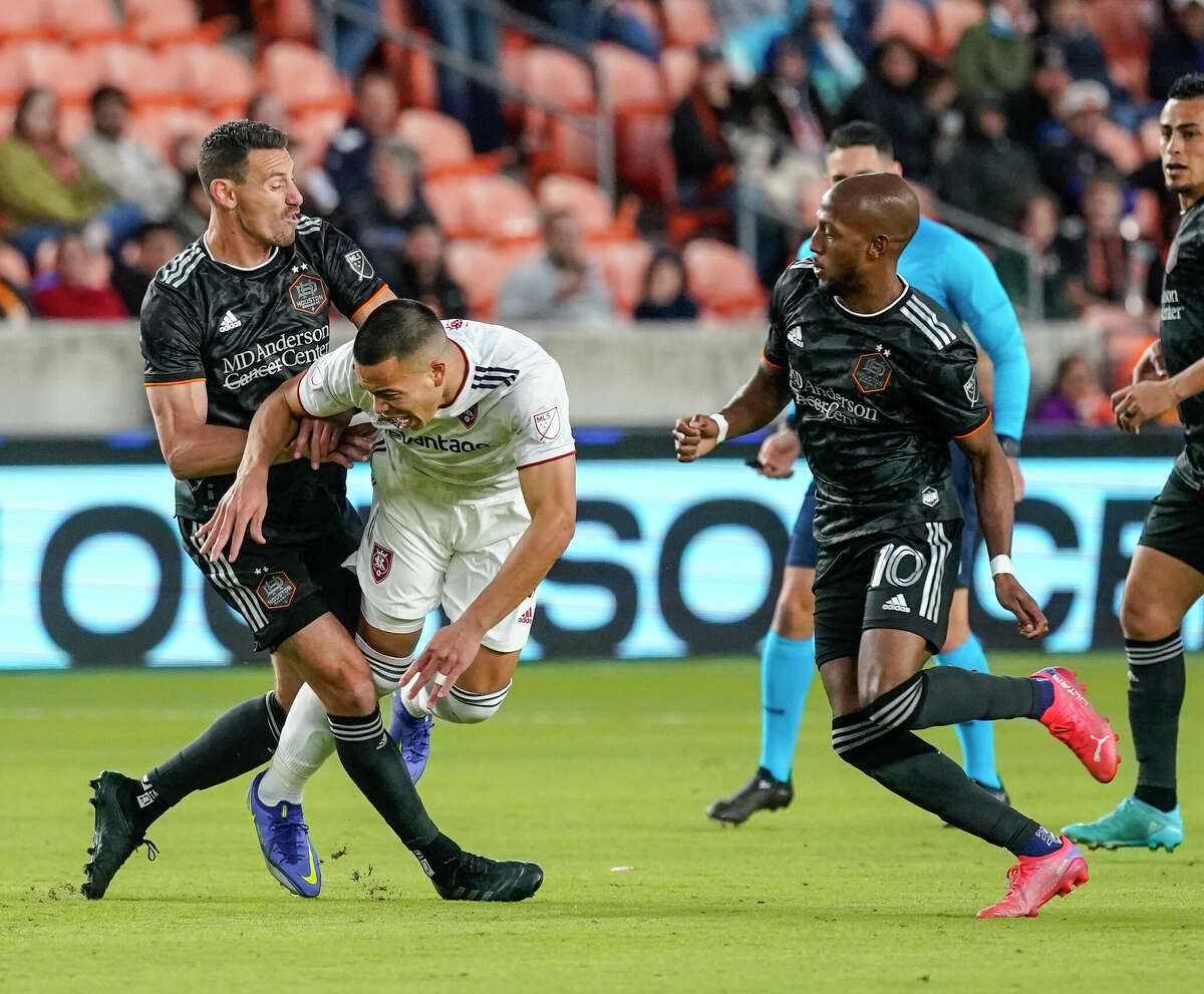 Houston Dynamo FC defender Daniel Steres and forward Fafa Picault battle Real Salt Lake forward Bobby Wood during the first half of the home opener of an MLS game at PNC Stadium on Sunday, Feb. 27, 2022 in Houston.