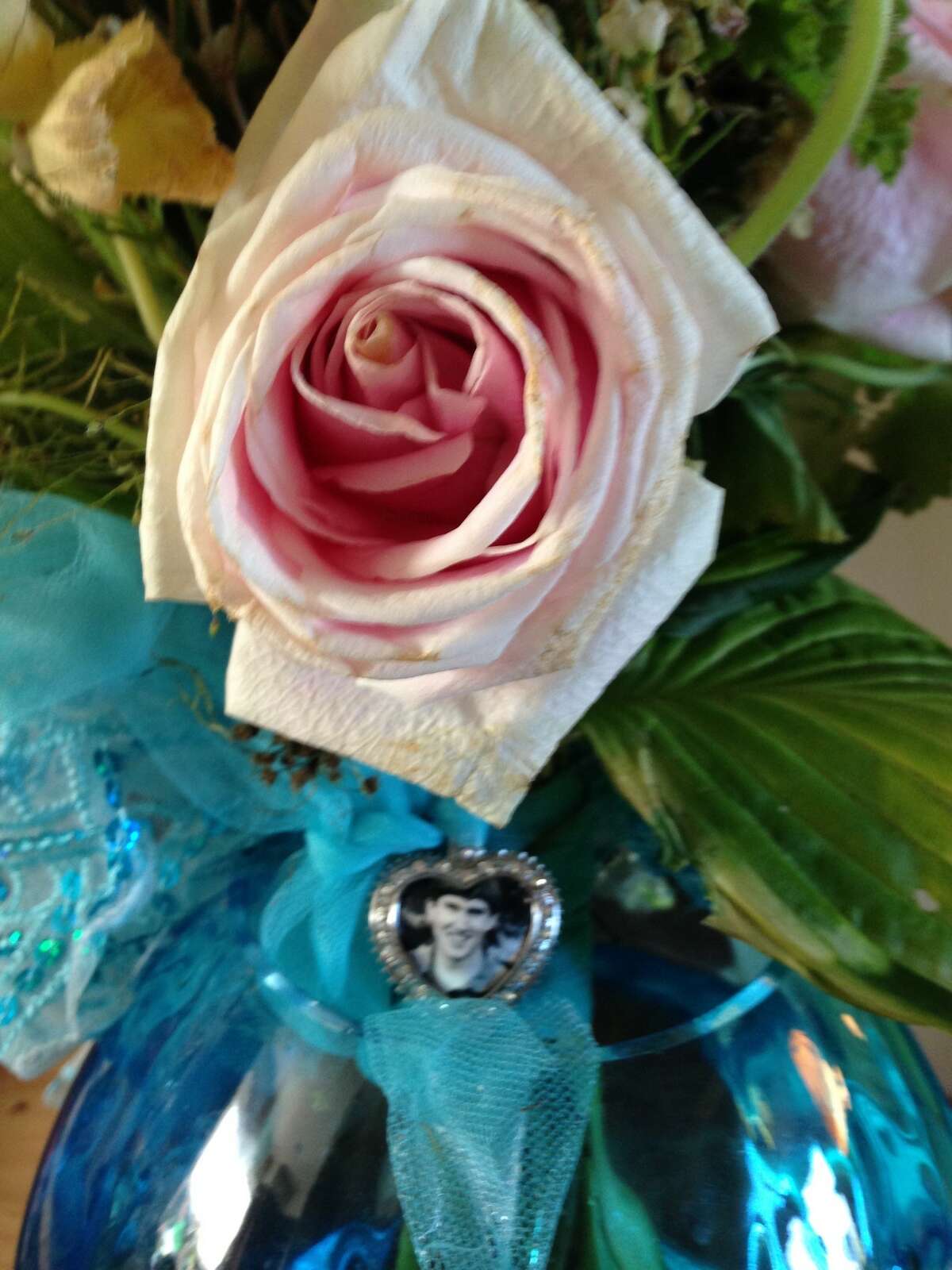 A small photo of Benjamin Llewellyn Lanners Ball in his sister Lia's bridal bouquet. 