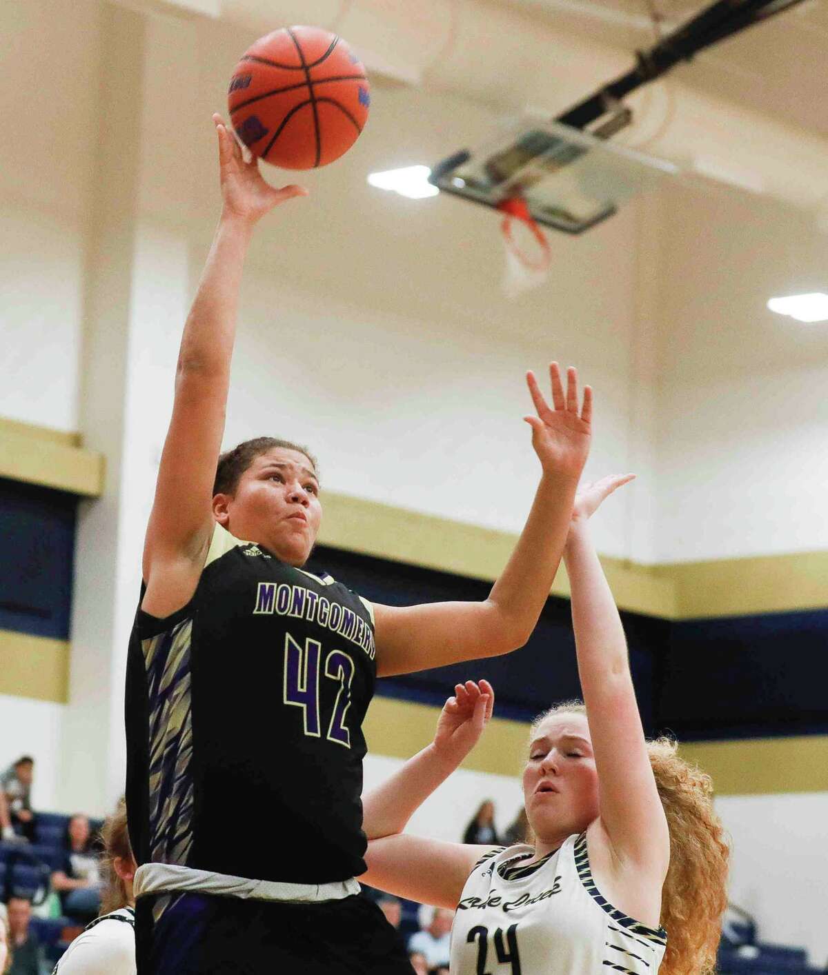 Montgomery forward Janessa Tennison (42) shoots over Lake Creek small forward Ava Anderson (24) in the first quarter of a District 20-5A high school basketball game at Lake Creek High School, Tuesday, Jan. 25, 2022, in Montgomery.