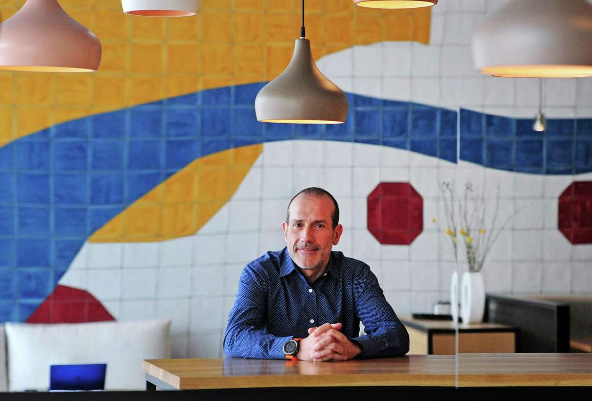 Carlos Pia, owner of DeTapas restaurant, poses in the new eatery in Westport, Conn., on Friday February 25, 2022.