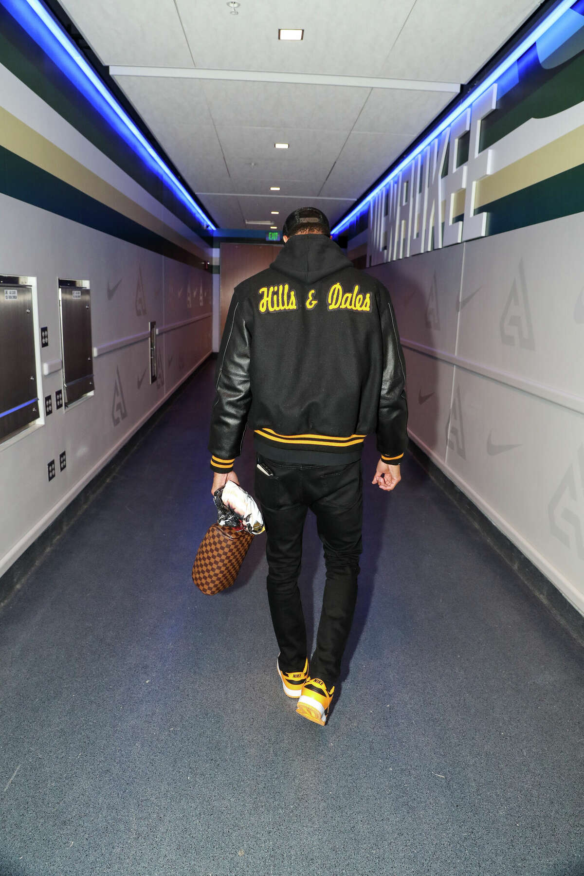Milwaukee Bucks guard George Hill sported a Hills and Dales-branded letterman to the Bucks vs. Brooklyn Nets game on Saturday, February 26, 2022. 