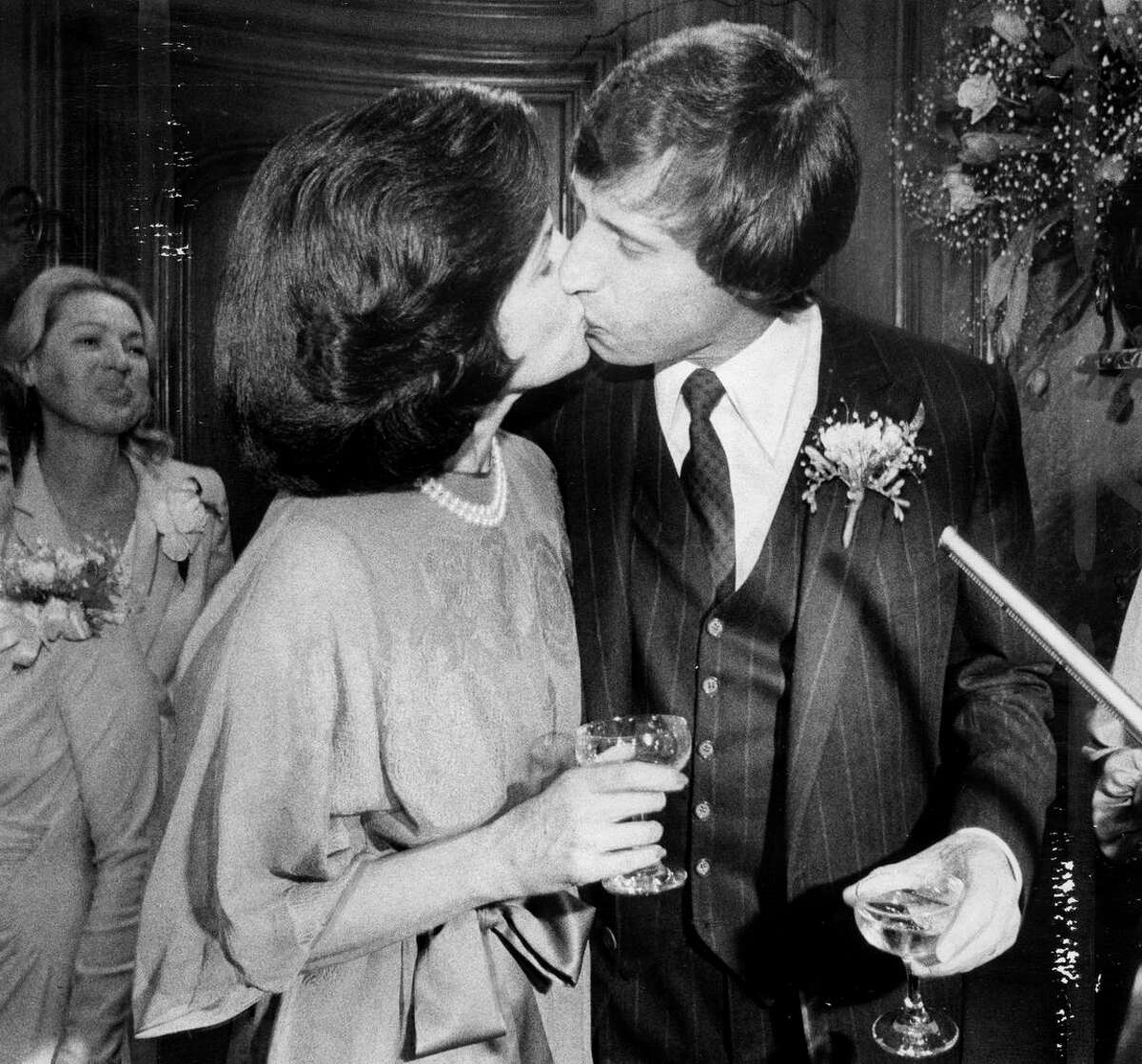 Mayor Dianne Feinstein of San Francisco and investment banker Richard Blum, who married in 1980, share a kiss in her office.