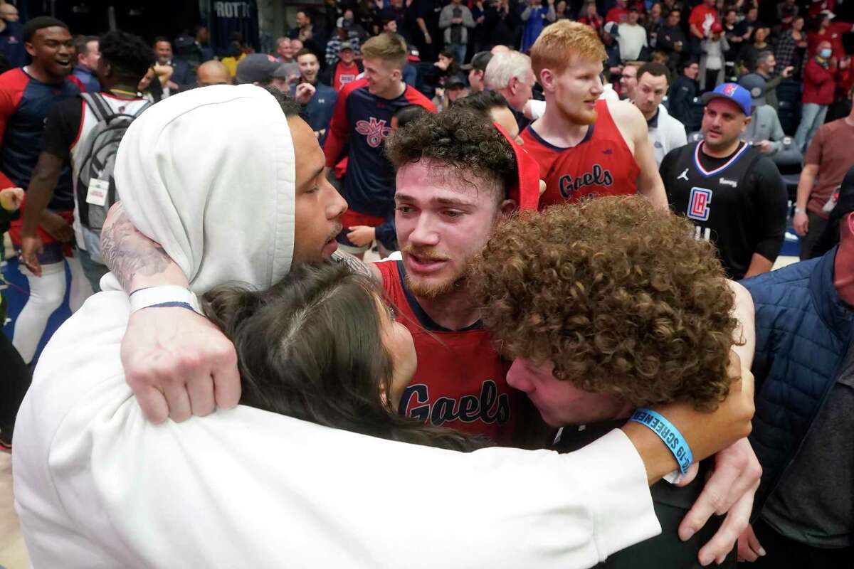 Saint Mary's guard Logan Johnson, middle, is congratulated after Saint Mary's defeated Gonzaga in an NCAA college basketball game in Moraga, Calif., Saturday, Feb. 26, 2022. (AP Photo/Jeff Chiu)