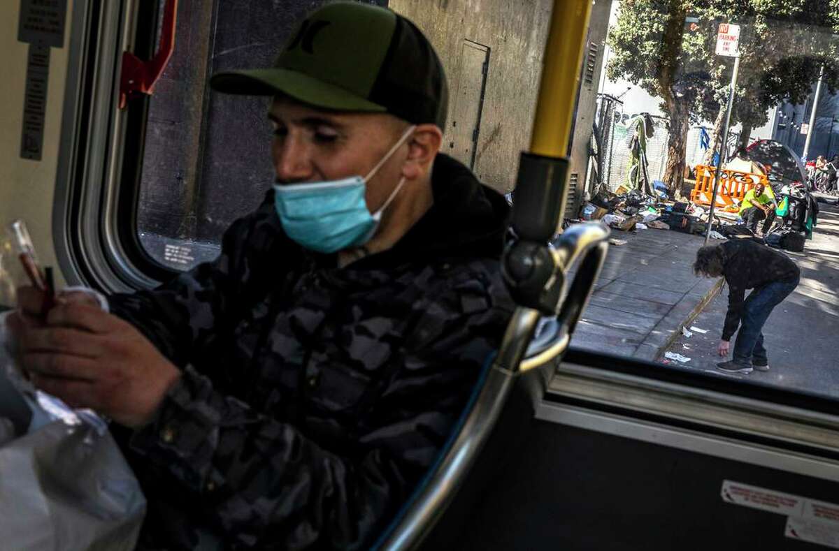 T.J. Johnson, a fentanyl addict who recently got housing through the city’s Tenderloin Linkage Center, rides a Muni bus to visit his girlfriend.