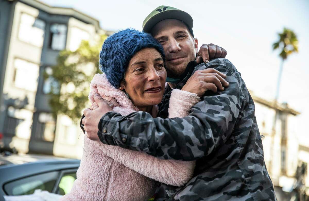 T.J. Johnson embraces his girlfriend, Justine. Johnson, who is addicted to fentanyl, has been a frequent visitor to the controversial Tenderloin Linkage Center and is supportive of its harm reduction approach versus abstinence-based programs.