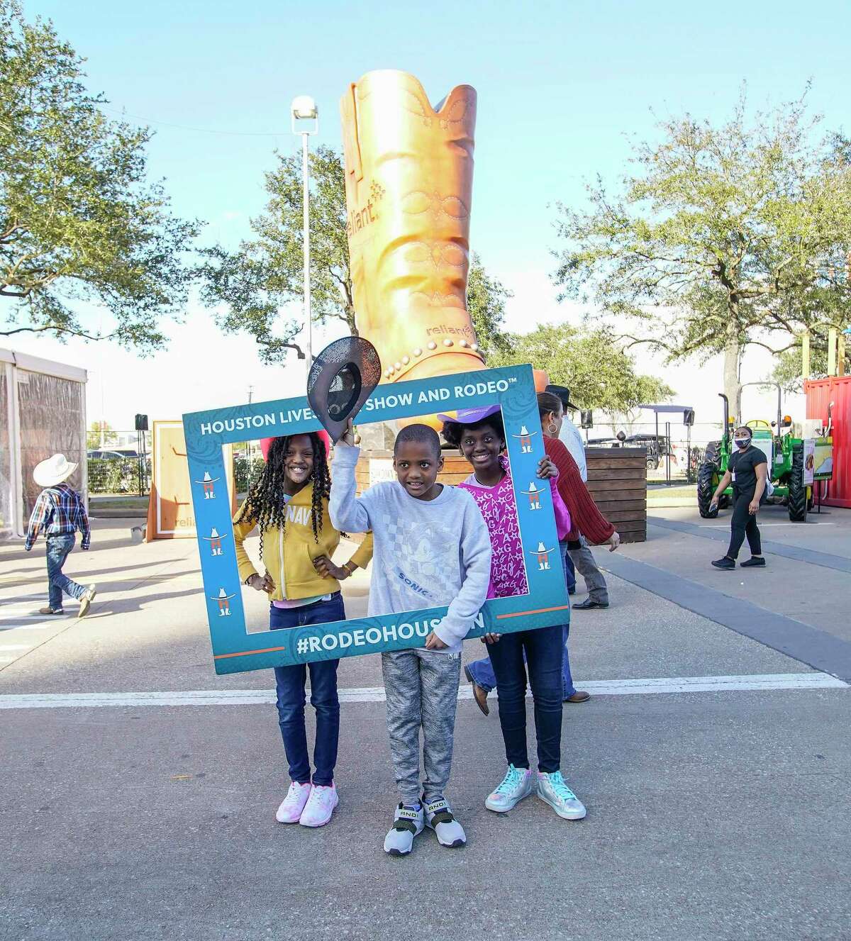 Amaya Washington, 10, left, with her brother, D.J., 9, and sister Ava, 10, get their photo taken by their parents during opening day of the Houston Livestock Show and Rodeo at NRG Park on Monday, Feb. 28, 2022 in Houston.
