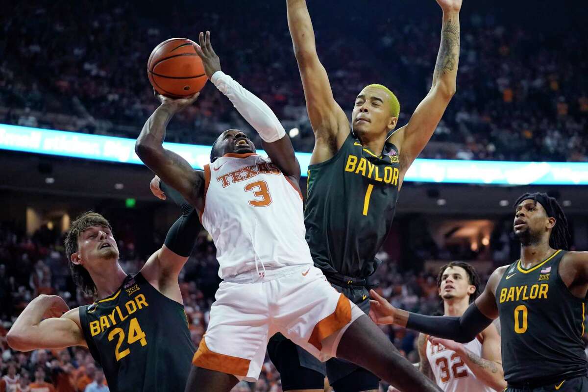 Texas guard Courtney Ramey runs into traffic on a drive to the basket in the form of Baylor’s Matthew Mayer (24) and Jeremy Sochan (1).