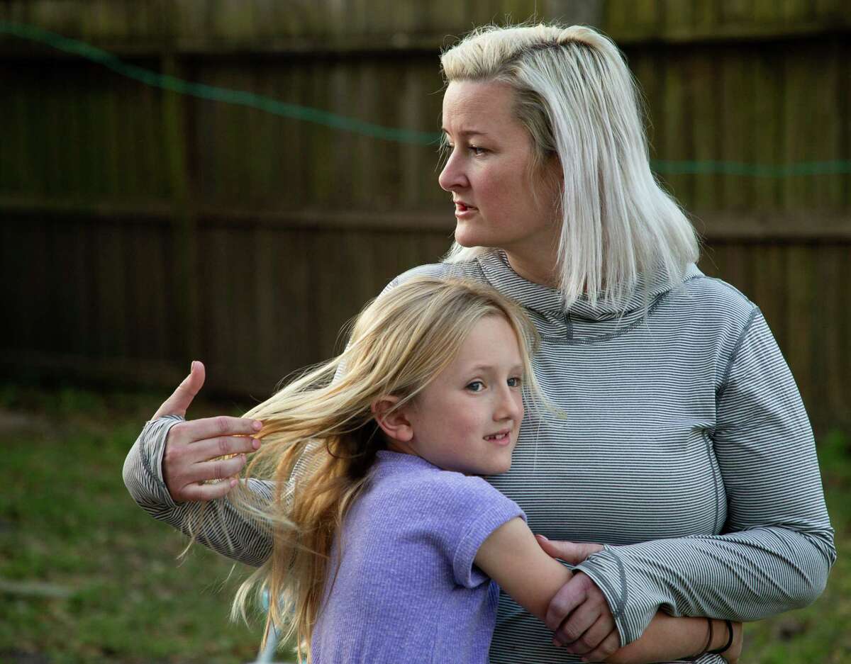 Rebekah Bryant plays with Sunny’s hair while at the family’s backyard on Monday, Feb. 28, 2022, in Houston.