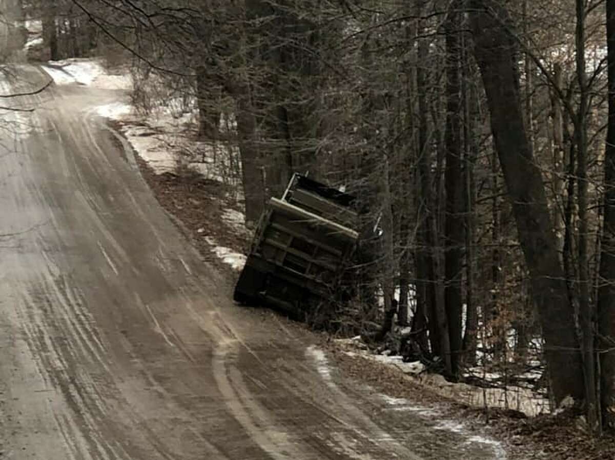 A Lake County Road Commission truck lands in the ditch while treating the road on 40th near the Sid Woods farm during the recent 100 year ice storm.