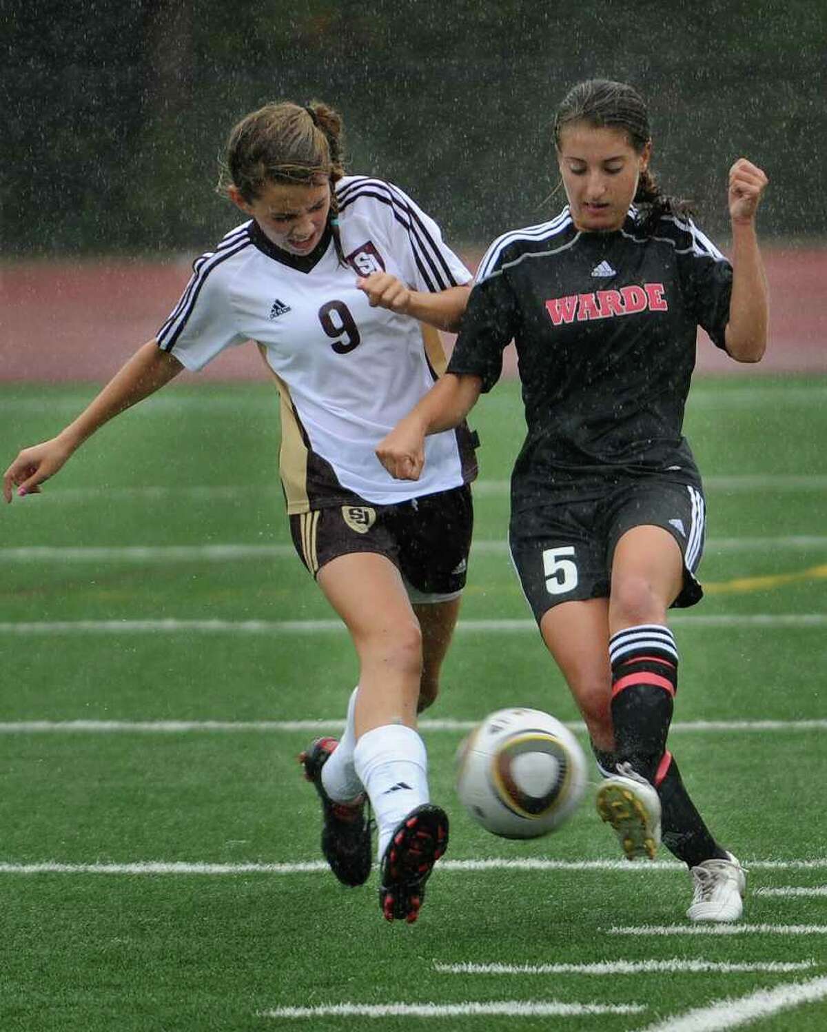 St. Joseph's Sabrina Toole and Fairfield Warde's Carly Mappa converge on the ball during their 1-1 tie at St. Joseph High School in Trumbull on Monday, September 27, 2010.
