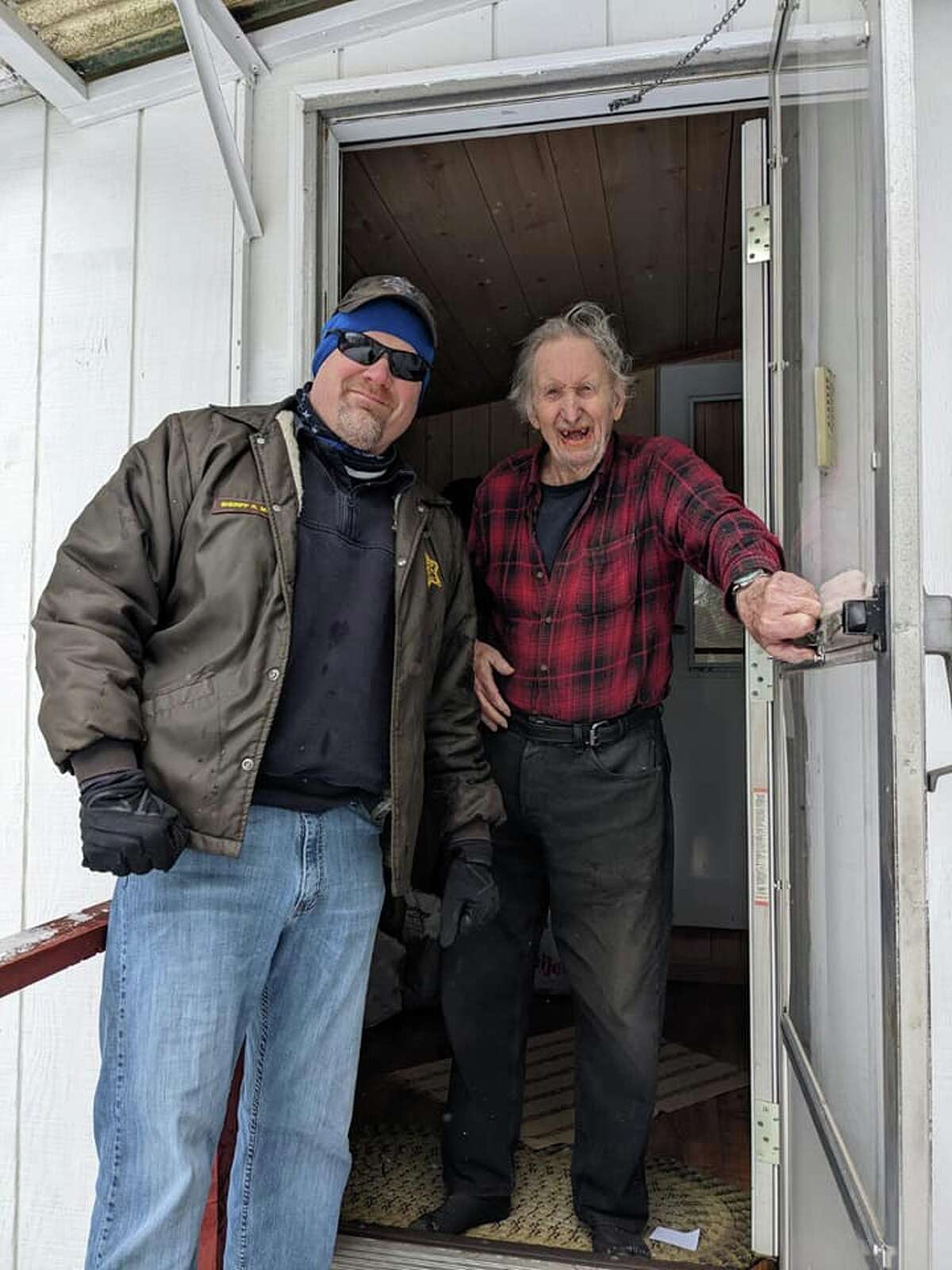 Lake County resident and WWII veteran William Zwiegle, right, is all smiles as Lake County Sheriff Rich Martin, along with Pleasant Plains Fire Chief Chad Schaap and Manistee Forest ORV Club member Howard Campbell, work to replace his mailbox that was destroyed by an errant driver.