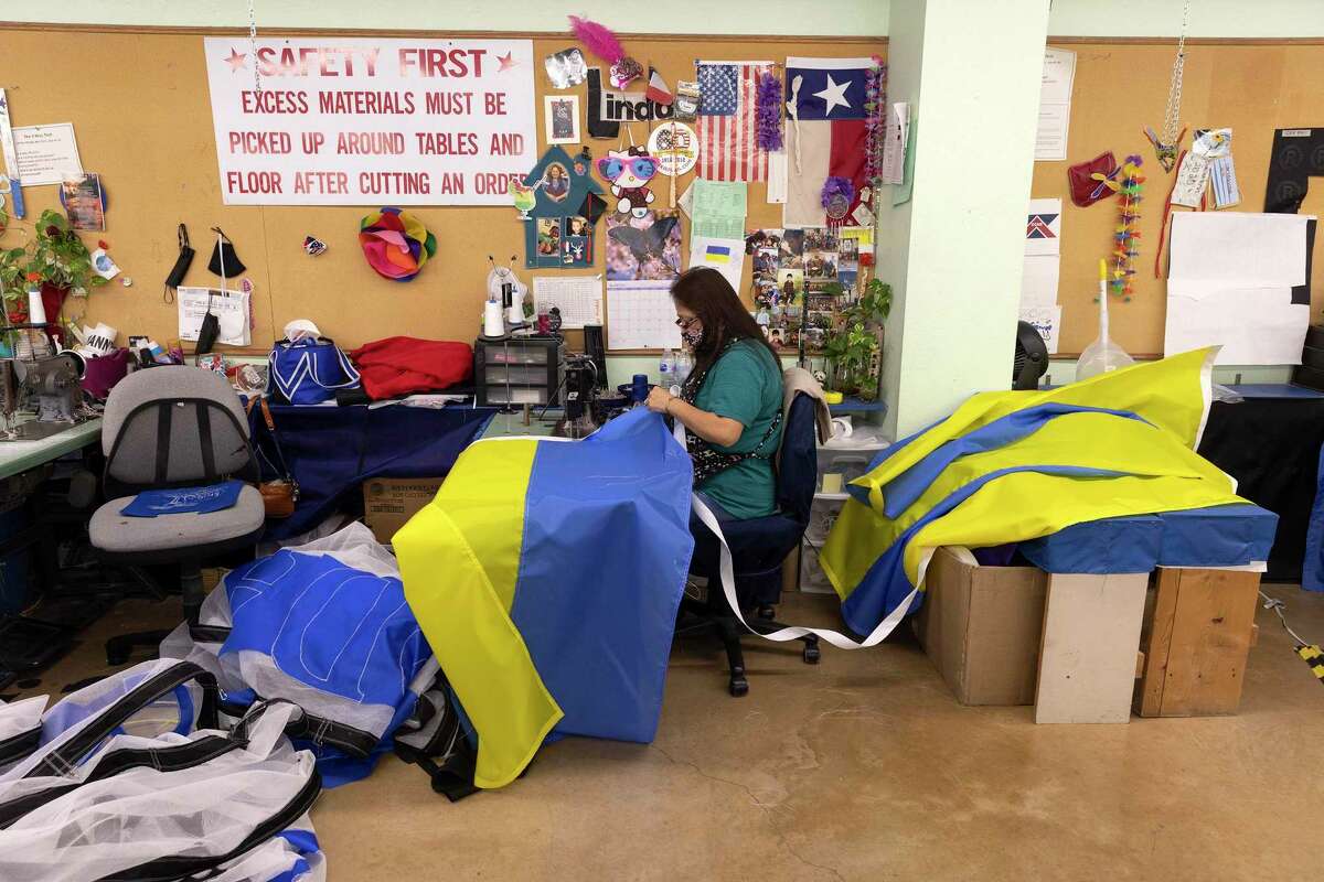 Linda Navarro, who has worked at Dixie Flag and Banner for six years, stitches Ukrainian flags Tuesday. Customer demand is high and there’s a wait list. Navarro says she is happy to see the support for Ukraine.