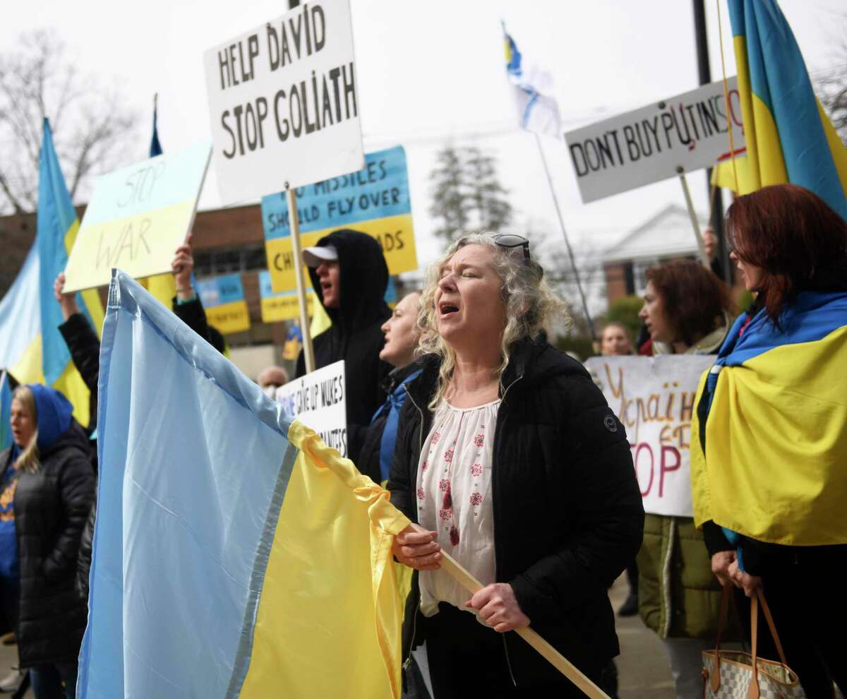 Stamford's Nataliya Trofort sings the Ukrainian National Anthem during the Rally for Ukraine outside Town Hall in Greenwich, Conn. Tuesday, March 1, 2022. More than 200 people came to Greenwich Town Hall Tuesday afternoon to rally support for Ukraine and urge swift action to stop the fighting after the Russian attack began last week.