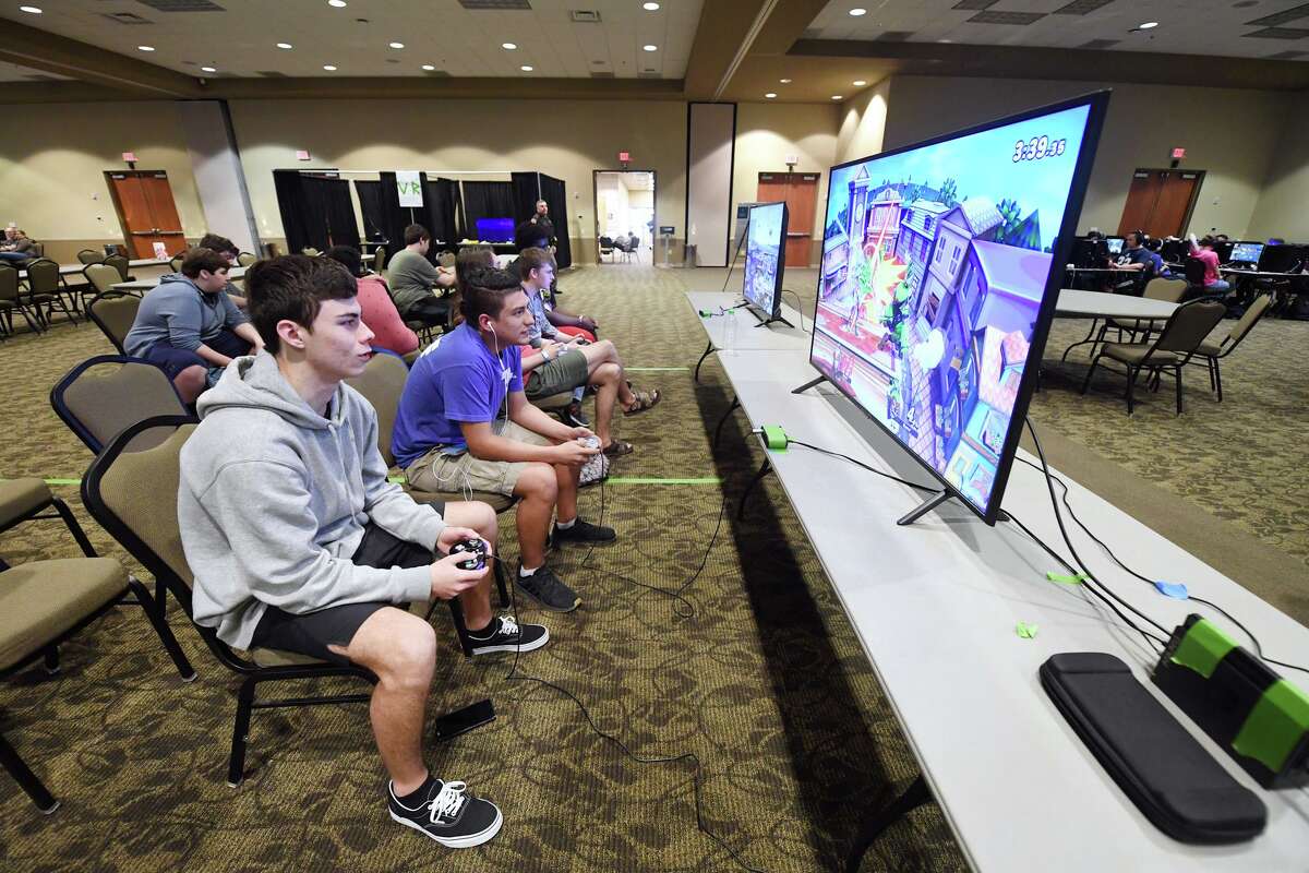 Reid Markowski and Carlos Anaya play Super Smash Bros. Ultimate during a gaming tournament in 2019. A Texas A&M study found that online gaming can have positive effects on mental health.