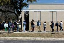 Voters wait in line to cast their votes at the Brook Hollow Branch of the San Antonio Library in the primary election Tuesday.