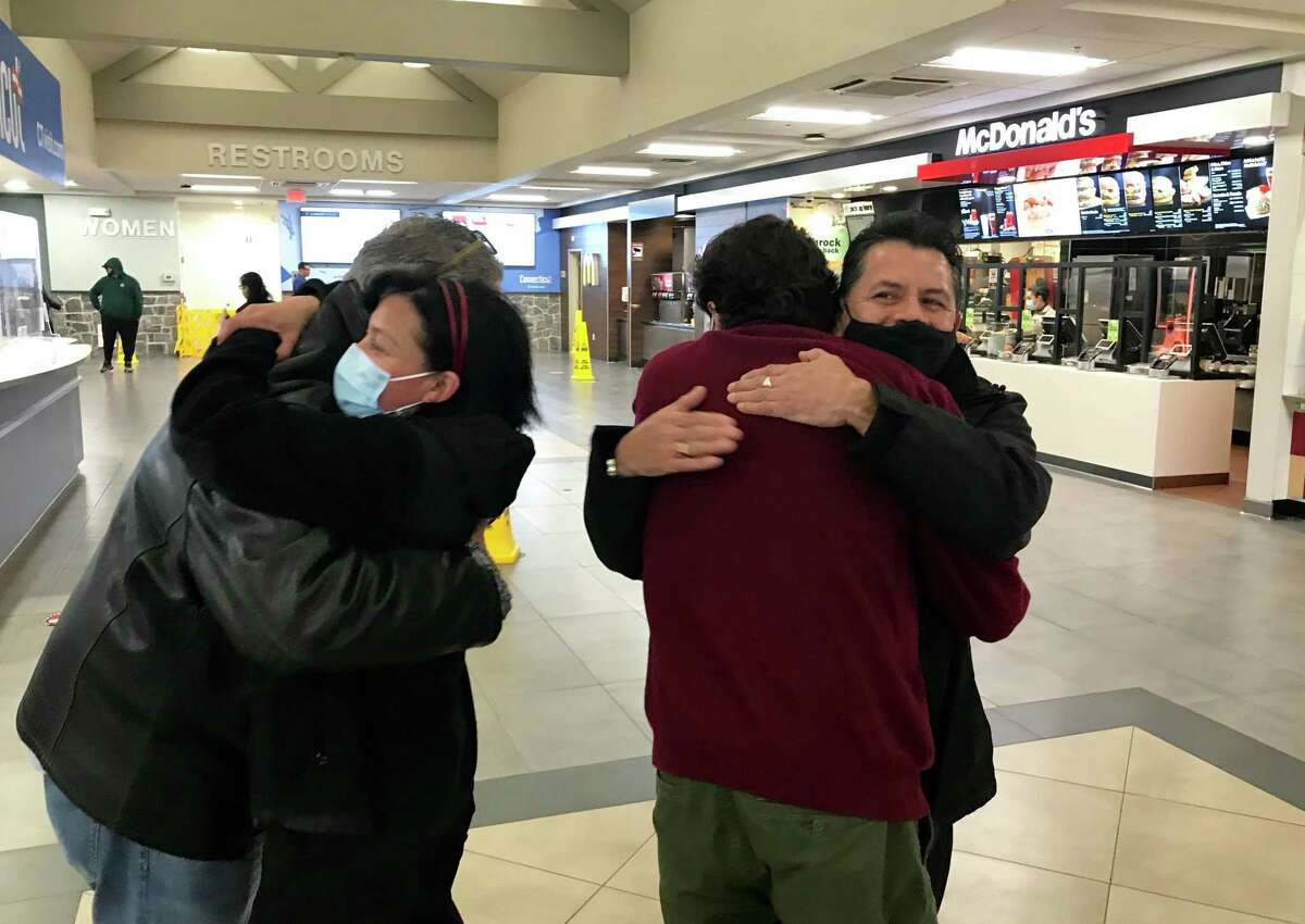 Rosa Franco, left, and Mario Franco hug union organizers from 32BJ SEIU seconds before they returned to work at McDonald’s in the Darien northbound service plaza on Interstate 95 on Monday night, for the first time since the pandemic hit. Rosa and Mario, who are not related, are two of the four McDonald’s workers reinstated in their jobs with back pay after an administrative law judge found the franchise has punished them for union activity.