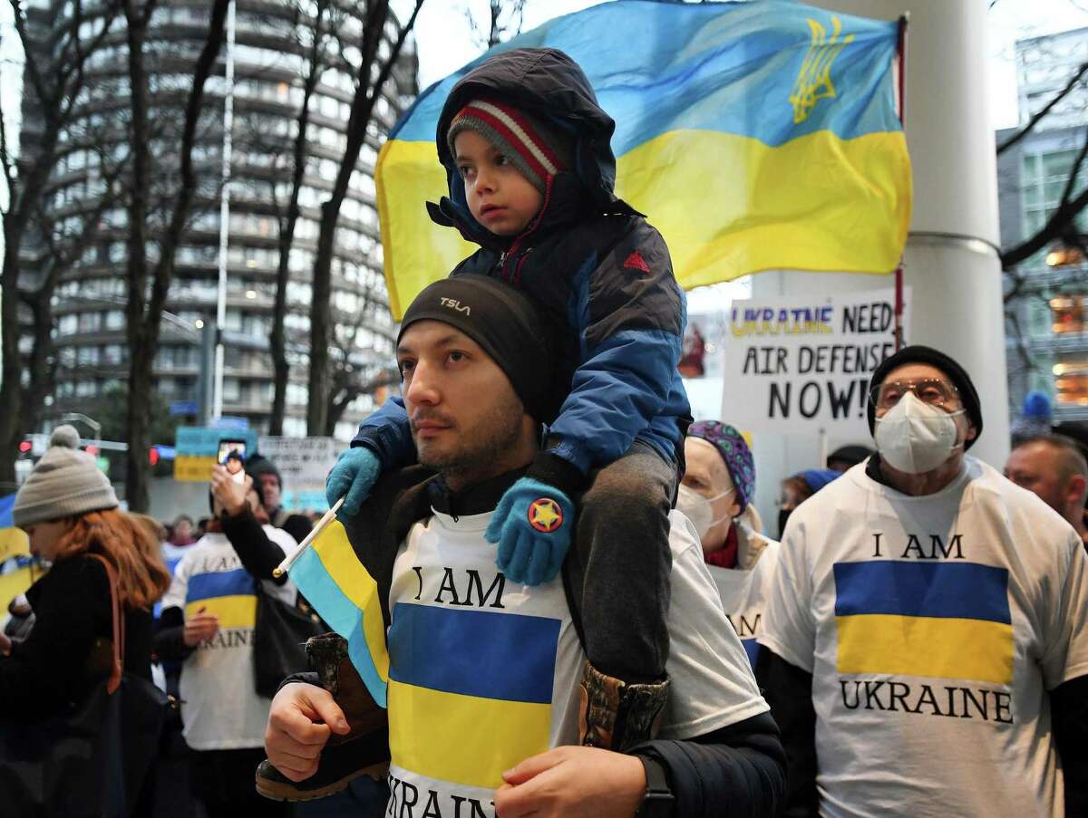 Ukrainian Aziz Rasulov, of Wilton, brought his son, Daniel, 6, with him to protest the Russian invasion of his homeland outside the Government Center in Stamford on Tuesday.