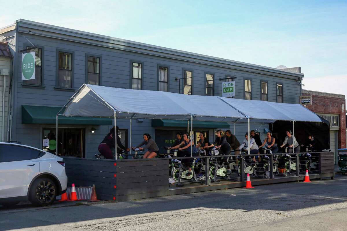 A spin cycle class works out in a parklet in front of RIDE Oakland. The fitness studio built the parklet as part of the city’s Flex Streets program.