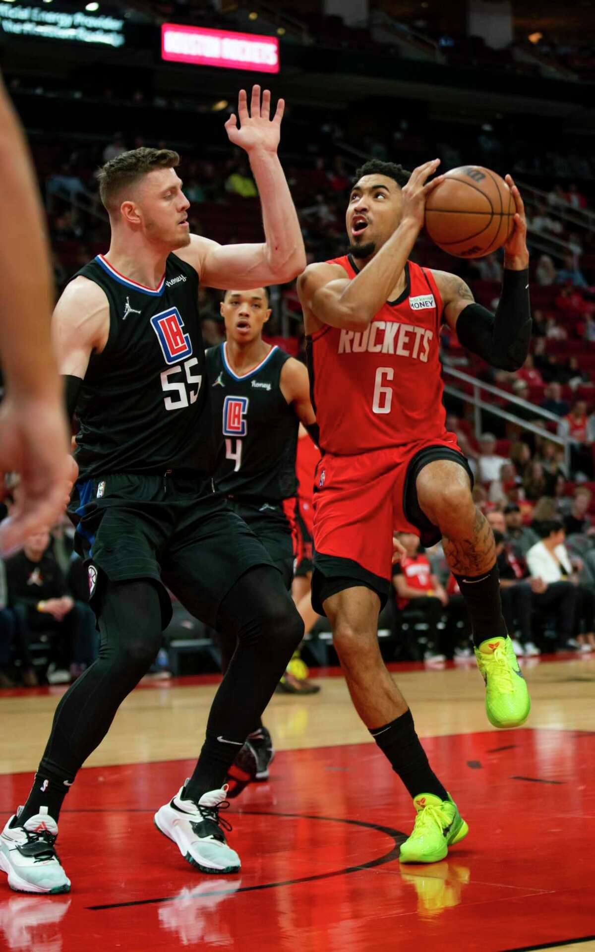 Houston Rockets forward Kenyon Martin Jr. (6) drives past Los Angeles Clippers center Isaiah Hartenstein (55) during the first half of an NBA game between the Houston Rockets and Los Angeles Clippers, Tuesday, March 1, 2022, at Toyota Center in Houston.