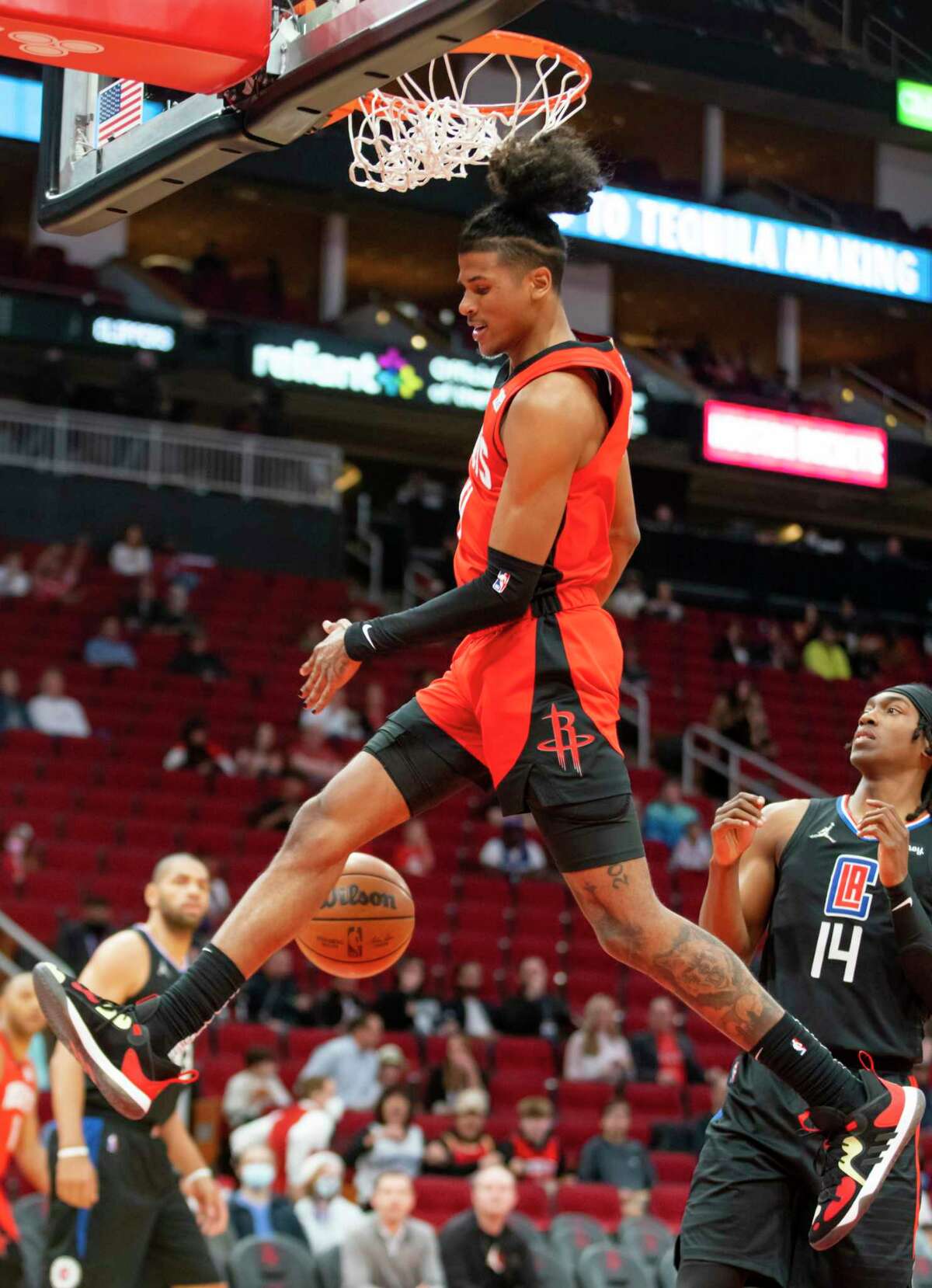 Houston Rockets guard Jalen Green (0) finishes a dunk ver Los Angeles Clippers guard Terance Mann (14) during the first half of an NBA game between the Houston Rockets and Los Angeles Clippers, Tuesday, March 1, 2022, at Toyota Center in Houston.