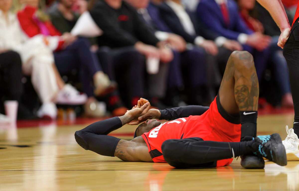 Houston Rockets guard Dennis Schroder (17) lays on the ground after tweaking his right ankle during the first half of an NBA game between the Houston Rockets and Los Angeles Clippers, Tuesday, March 1, 2022, at Toyota Center in Houston.