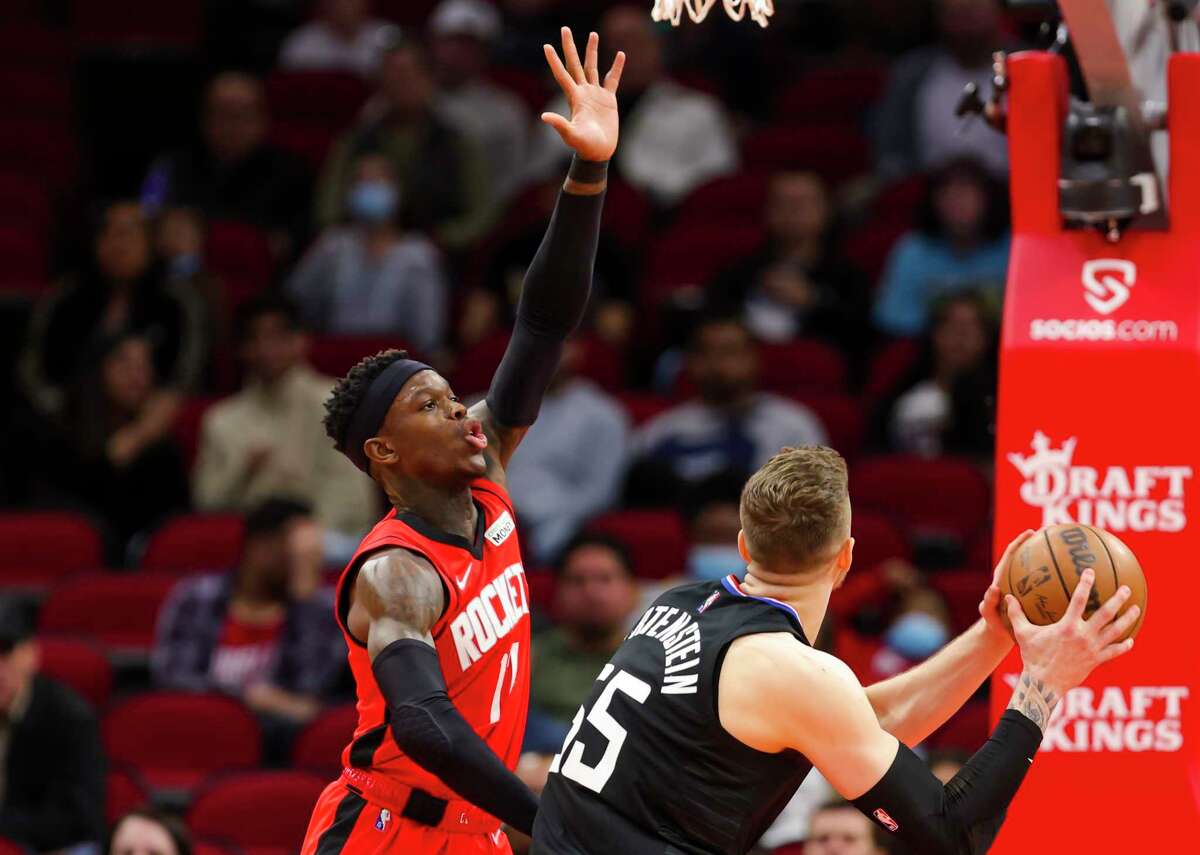 Houston Rockets guard Dennis Schroder (17) defends Los Angeles Clippers center Isaiah Hartenstein (55) during the first half of an NBA game between the Houston Rockets and Los Angeles Clippers, Tuesday, March 1, 2022, at Toyota Center in Houston.