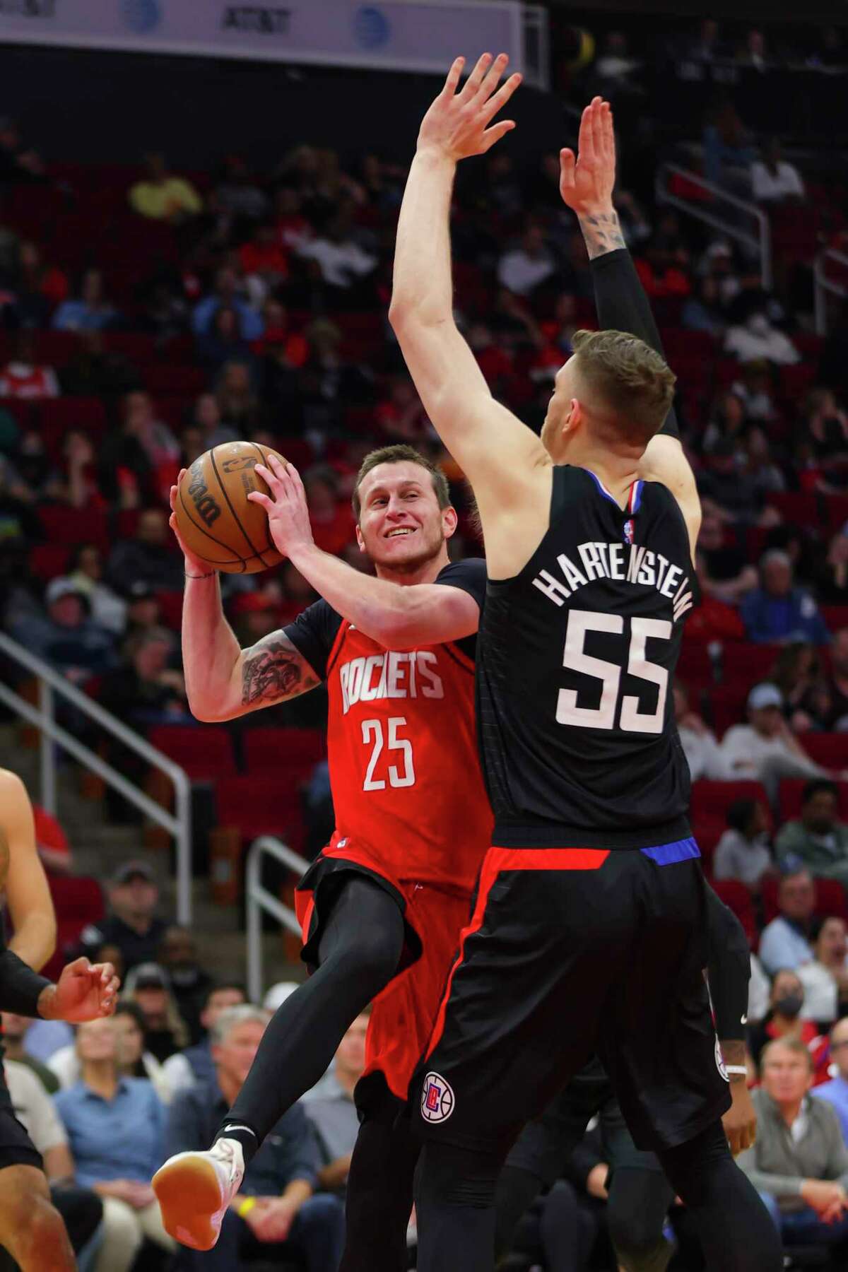 Houston Rockets guard Garrison Mathews (25) drives defended by Los Angeles Clippers center Isaiah Hartenstein (55) during the second half of an NBA game between the Houston Rockets and Los Angeles Clippers, Tuesday, March 1, 2022, at Toyota Center in Houston.