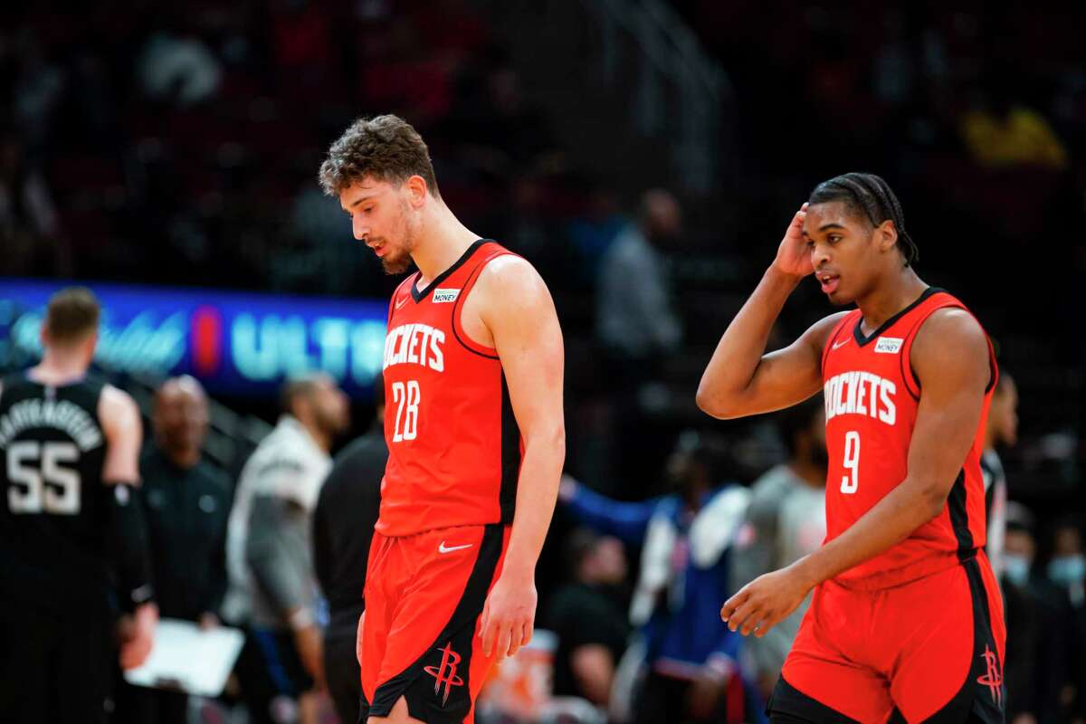 Houston Rockets center Alperen Sengun (28) and Houston Rockets guard Josh Christopher (9) walk back to the bench for a timeout during the second half of an NBA game between the Houston Rockets and Los Angeles Clippers, Tuesday, March 1, 2022, at Toyota Center in Houston.