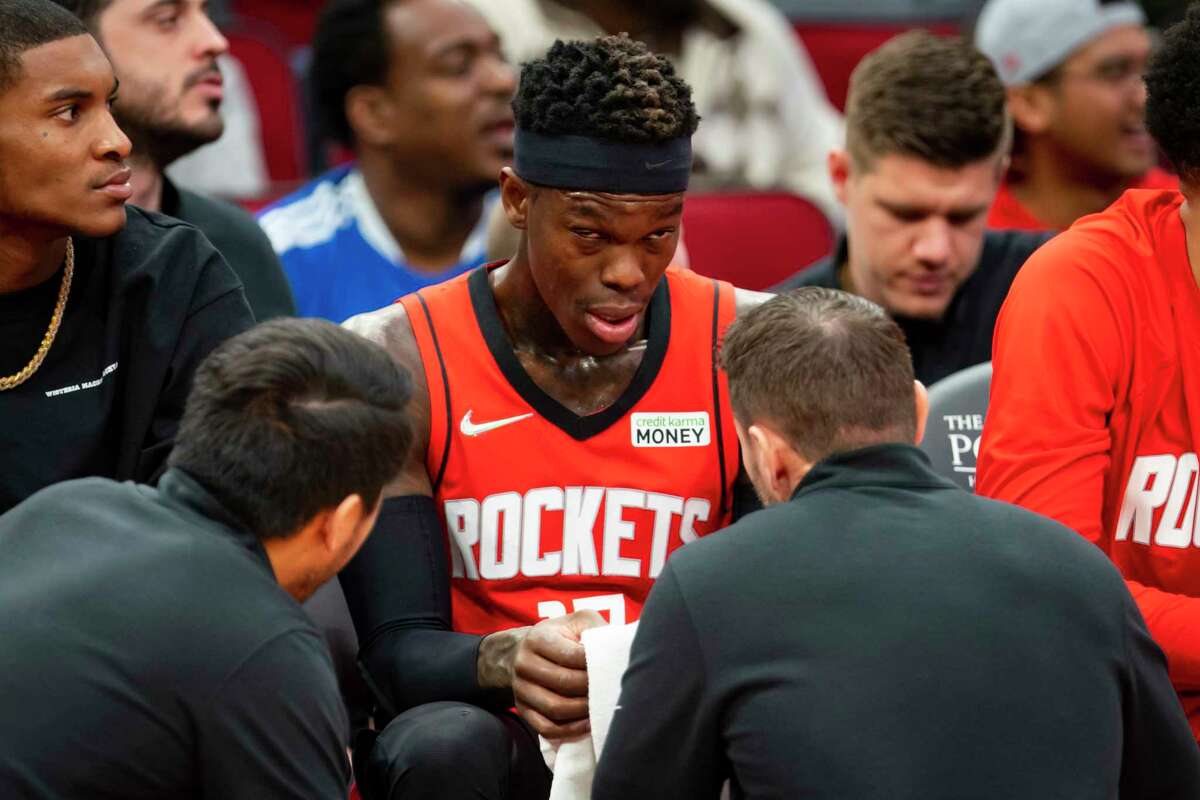 Rockets guard Dennis Schroder (17) has his right eye tended to by trainers during the second half. He was ruled out of Wednesday's game vs. the Jazz with a sprained ankle.