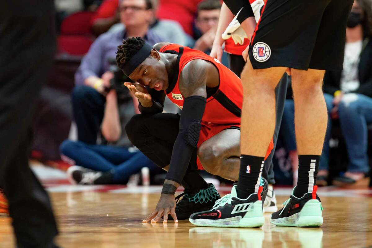 Houston Rockets guard Dennis Schroder (17) tends to his right eye after it was knocked during the second half of an NBA game between the Houston Rockets and Los Angeles Clippers, Tuesday, March 1, 2022, at Toyota Center in Houston.