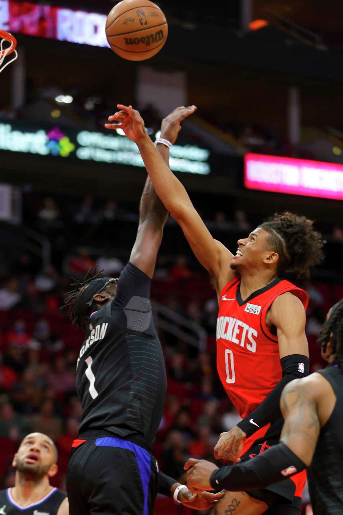 Houston Rockets guard Jalen Green (0) shoots over Los Angeles Clippers guard Reggie Jackson (1) during the second half of an NBA game between the Houston Rockets and Los Angeles Clippers, Tuesday, March 1, 2022, at Toyota Center in Houston.