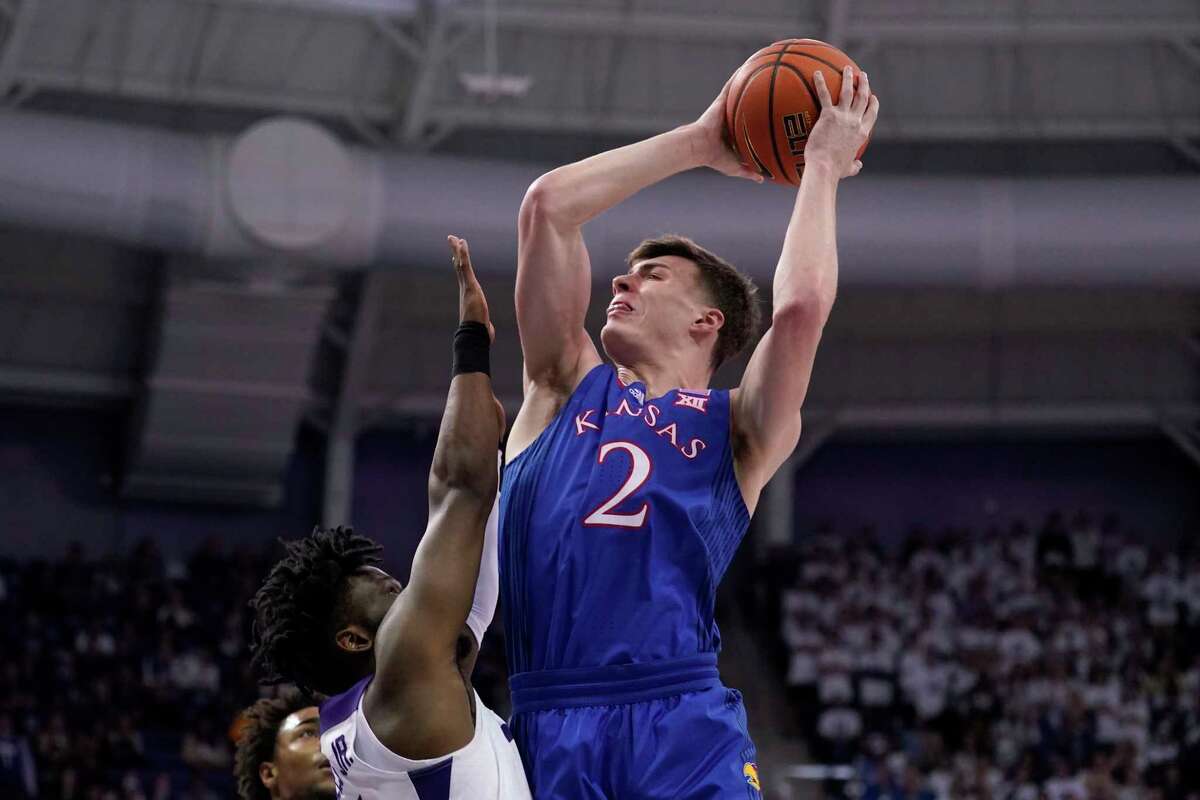 TCU guard Mike Miles, left, defends against a shot by Kansas guard Christian Braun (2) in the first half of an NCAA college basketball game in Fort Worth, Texas, Tuesday, March 1, 2022.