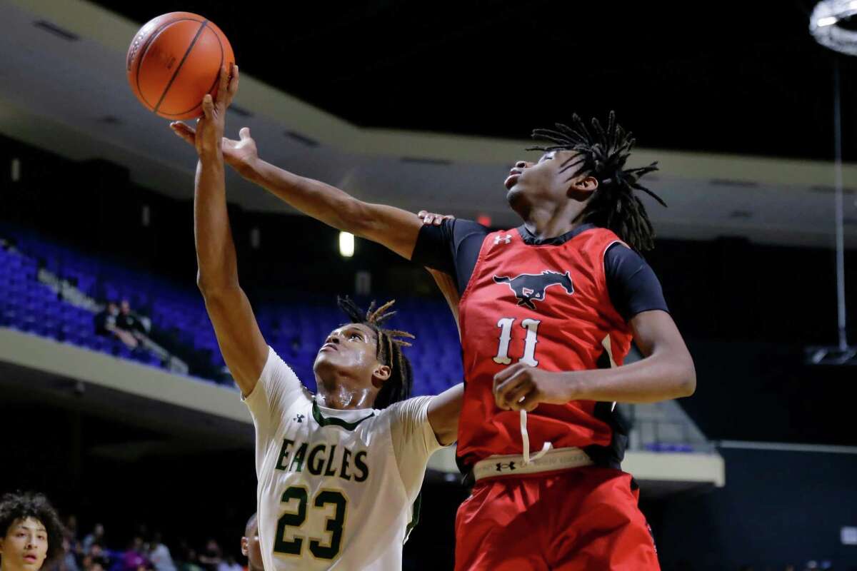 Cypress Falls’ Jesaiah McWright (23) and Westfield’s Jutaun Clopher (11) battle for a rebound during the first half of their UIL Region II-6A boys basketball regional quarterfinals game held at the Berry Center Tuesday, Mar. 1, 2022 in Cypress, TX.