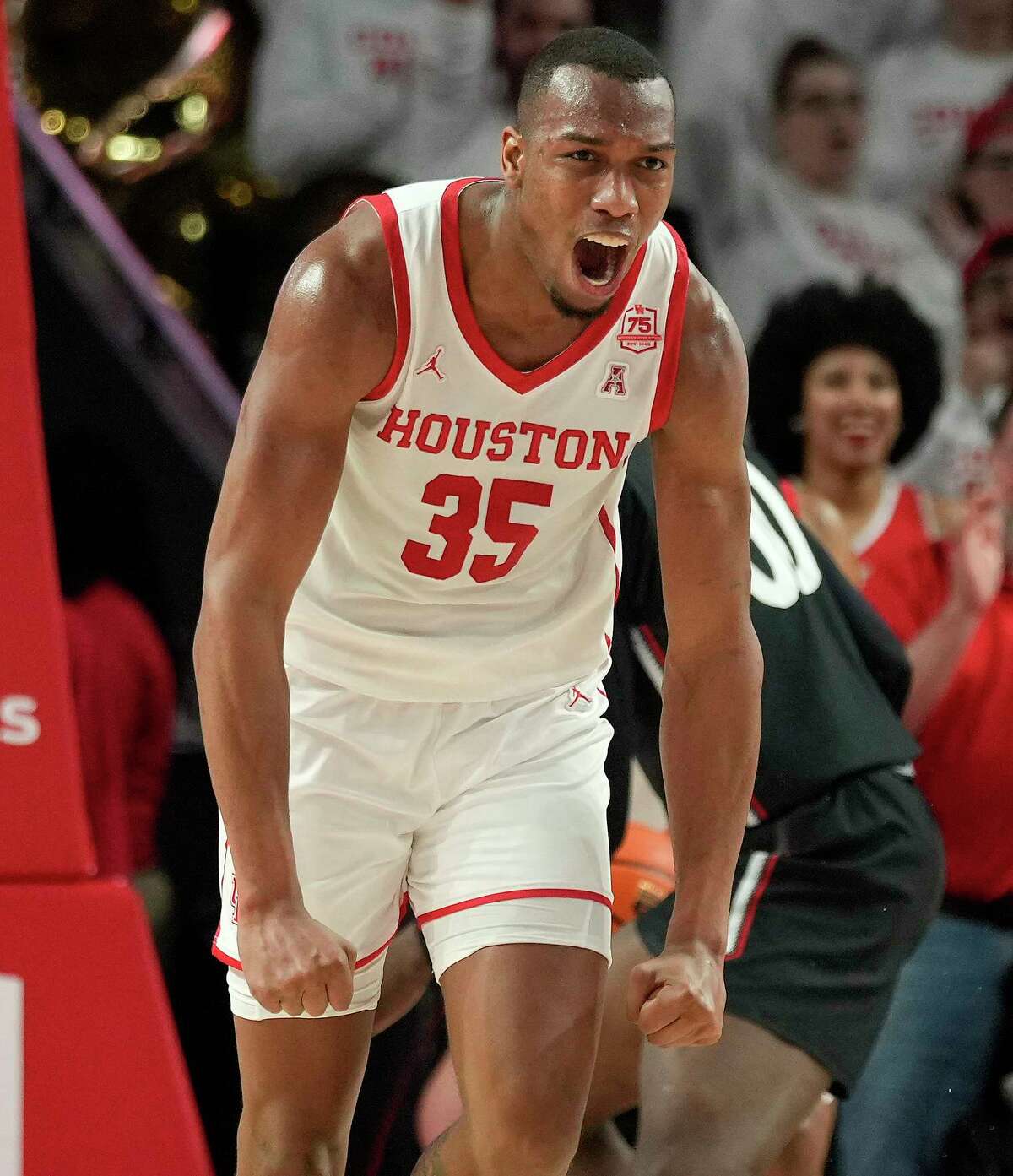 Houston forward Fabian White Jr. reacts after making a basket during the first half of an NCAA college basketball game against Cincinnati, Tuesday, March 1, 2022, in Houston.