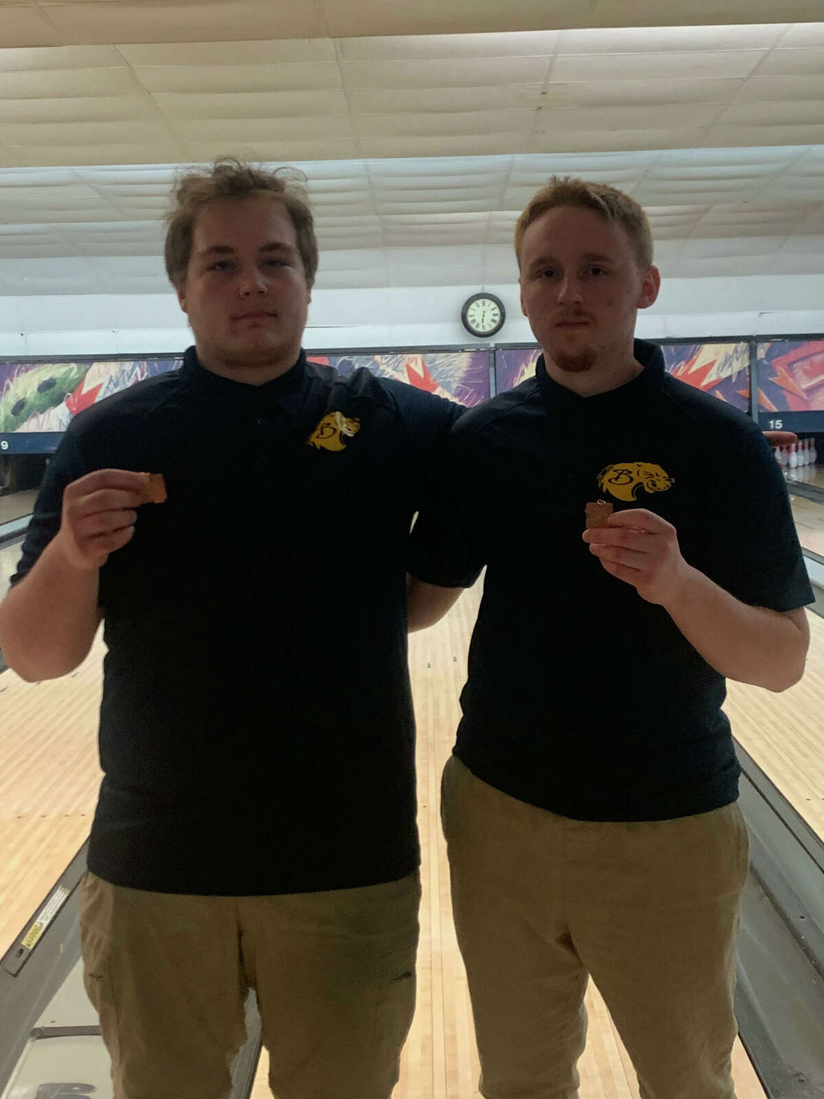 Adam McClure (left) and Jesse Pancio show the medals they earned from the regional.