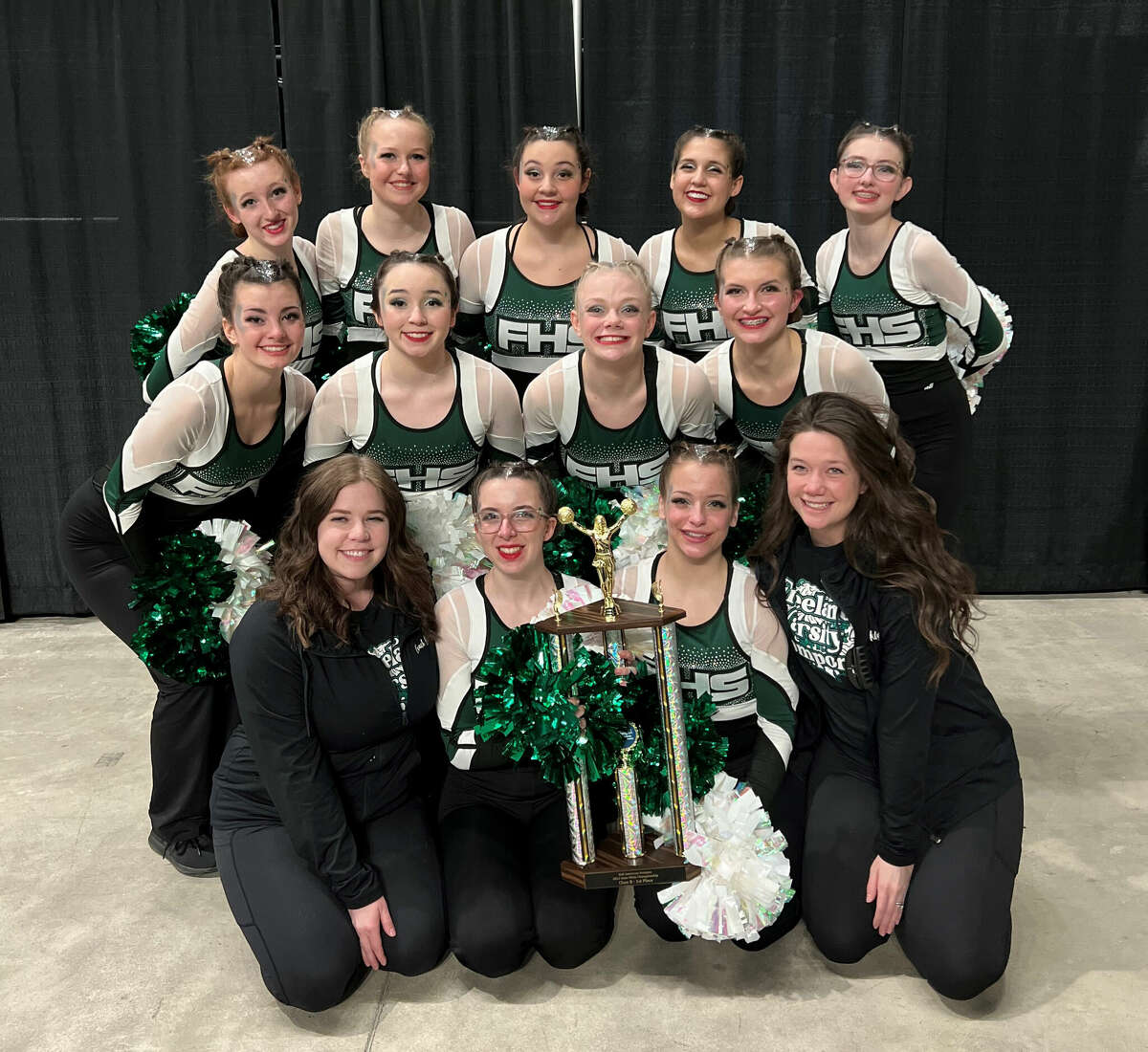 Members of Freeland's state champion pompon team are (front, from left) coach Brittany Newbold, Anna Armstrong, Makayla Cook, coach Kailyn Humphrey; (middle, from left) Lydia Stachowiak, Ava Wolinski, Hannah Abbe, Ava Reed; and (back, from left) Madison McLaughlin, Macie Trainor, Kenzie Schultz, Sasha Seegobin, and Michaela Lewis.