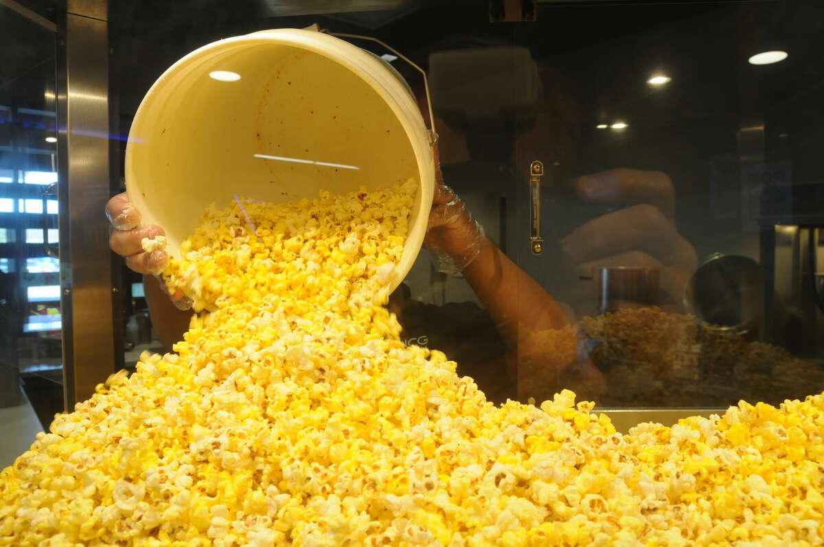 More popcorn is prepared in the NCG Cinema bin for the next round of shows. The Alton theater complex offers unlimited refills, as well as beer and alcohol sales.