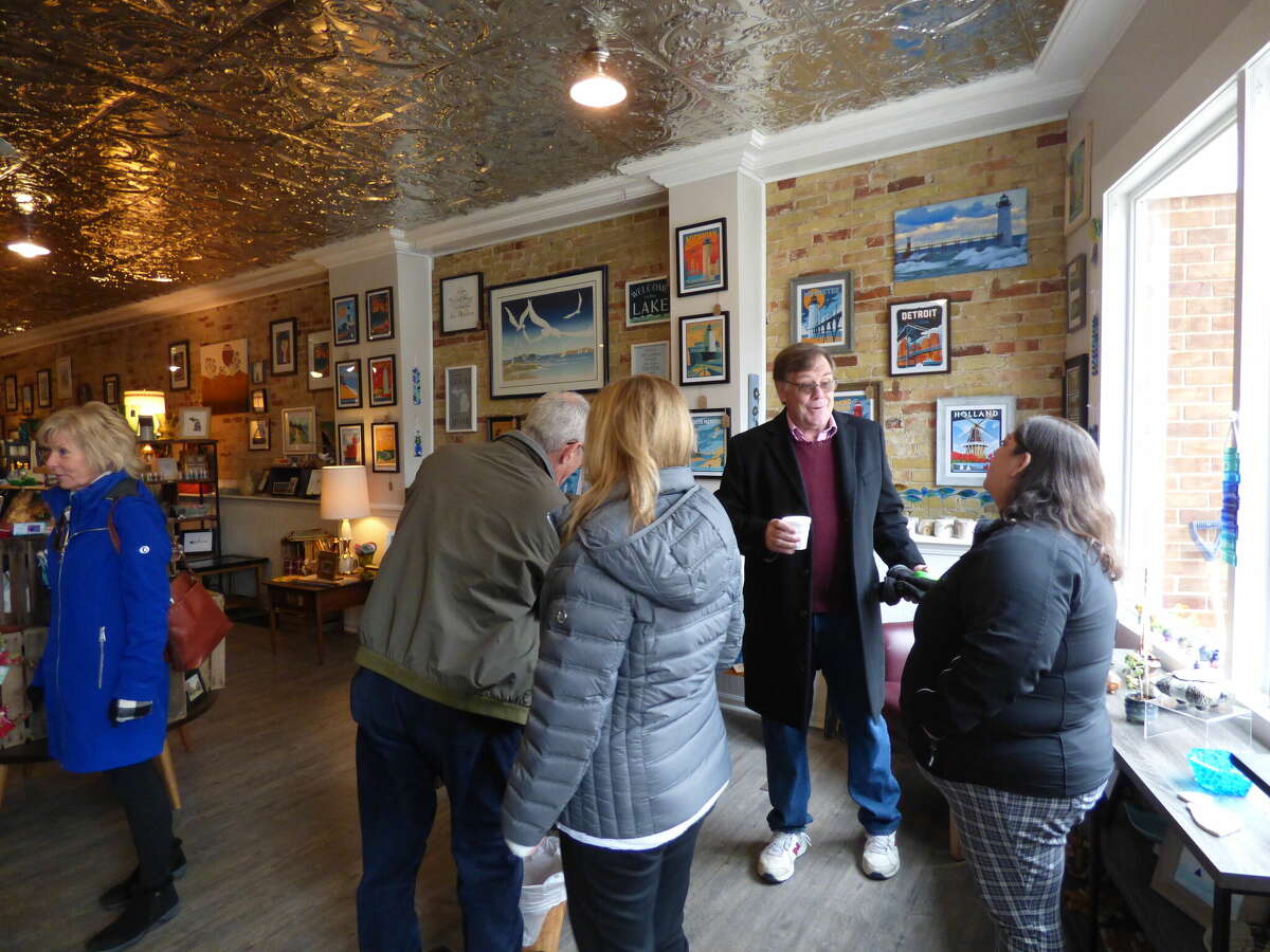 Manistee Area Chamber of Commerce Ambassadors and others welcome Port City Emporium to its new location on River Street.  