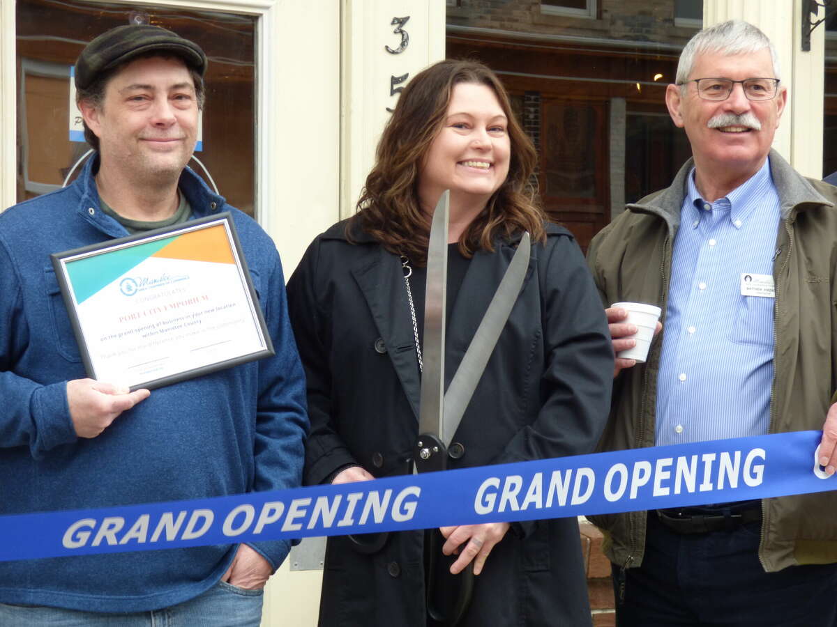 (Left to right) Patrick and Anita Shaffer at the grand opening of their newly reopened business, Port City Emporium, alongside Manistee Area Chamber of Commerce Ambassador Michael Knizacky, owner of the agency Knizacky Insurance.
