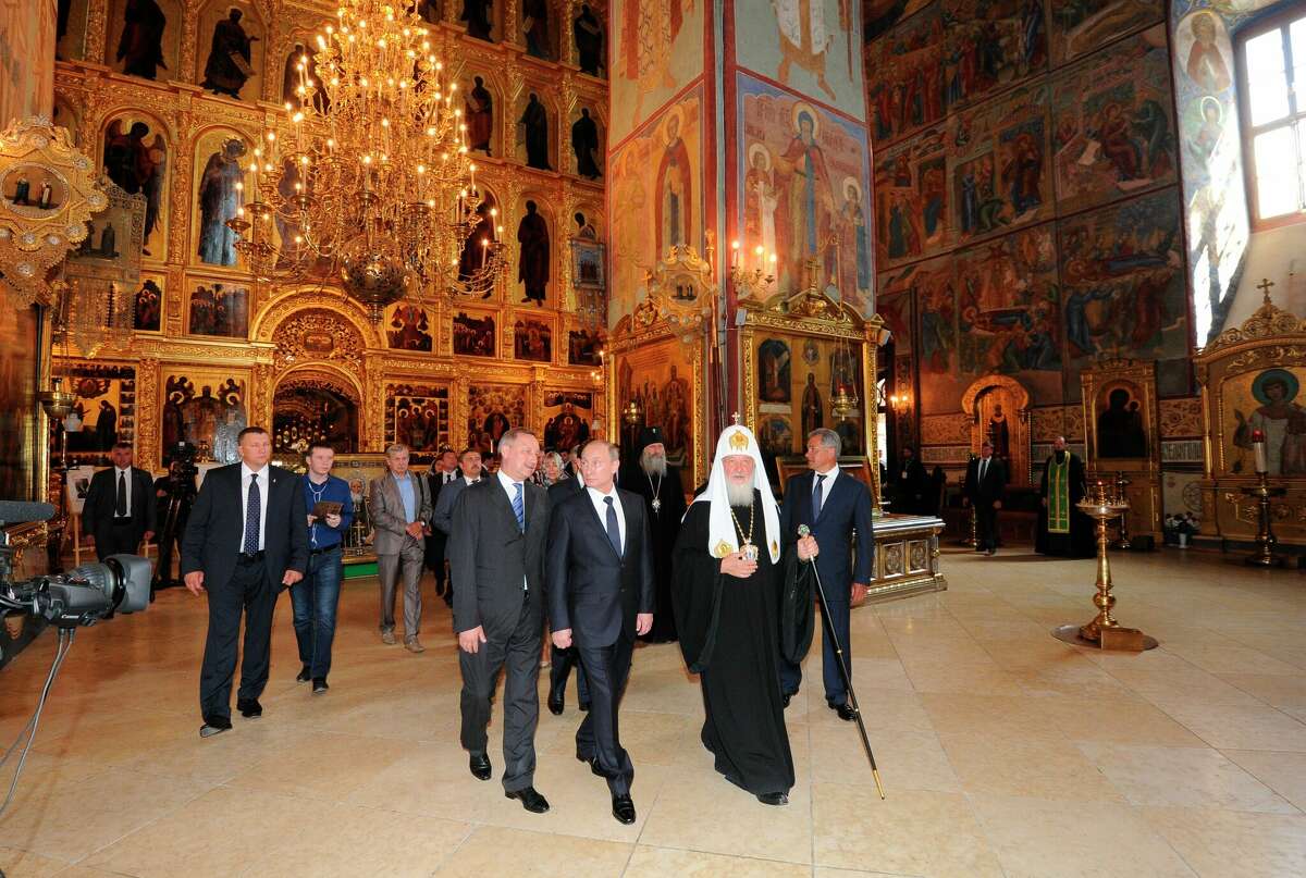 Russian President Vladimir Putin, front center, and Russian Orthodox Patriarch Kirill attend celebrations marking the 700th anniversary of St. Sergius of Radonezh in the Trinity St. Sergius monastery in Sergiyev Posad, northeast of Moscow, Friday, July 18, 2014. (AP Photo/RIA-Novosti, Mikhail Klimentyev, Presidential Press Service) ORG XMIT: MOSB106