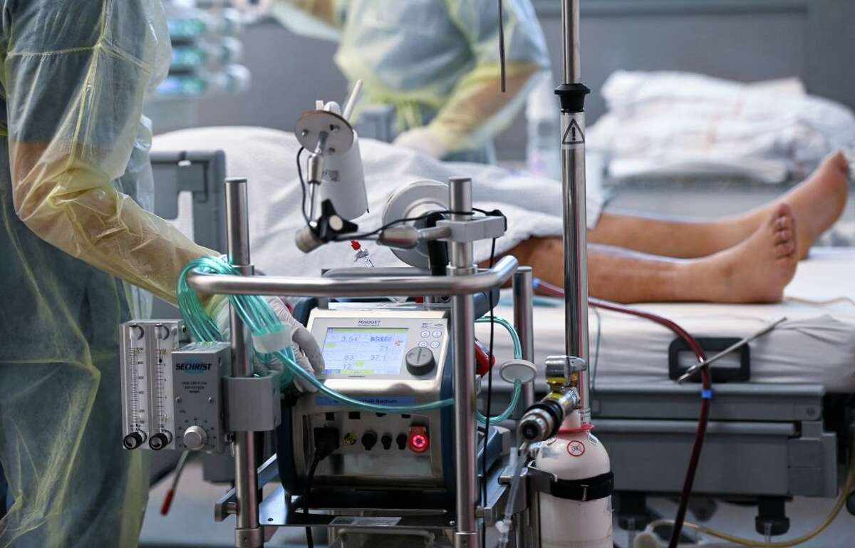 A patient affected by the COVID-19 coronavirus lies with a artificial respiration ECMO in the COVID-19 intensive care unit. (Photo by Ina Fassbender/AFP via Getty Images)