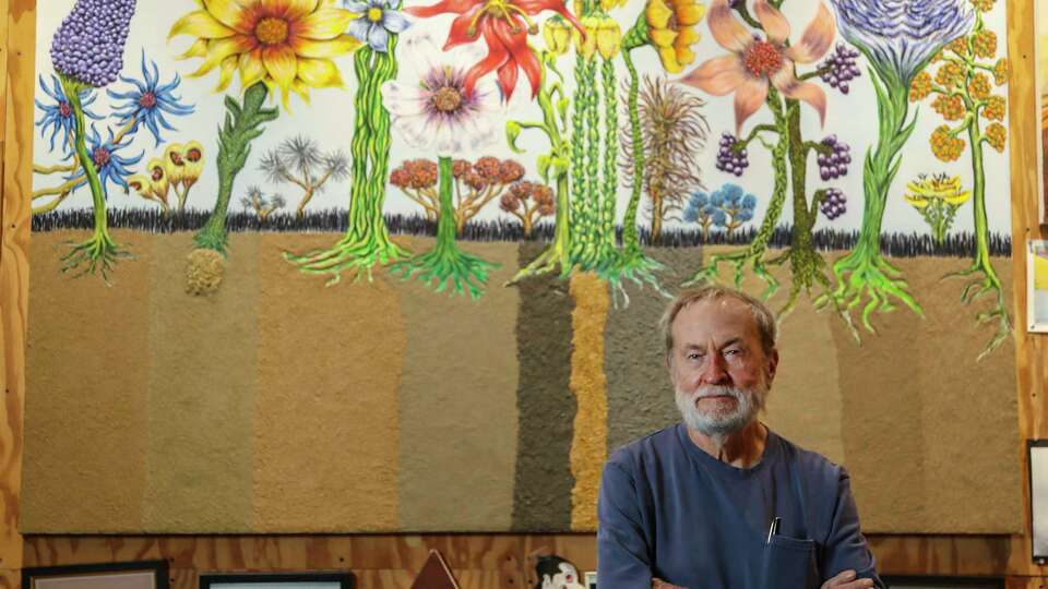 Portrait of Wayne Gilbert in his home studio with his art, Wednesday, Jan. 12, 2022 in Houston. Gilbert incorporates cremated human remains into his artwork.