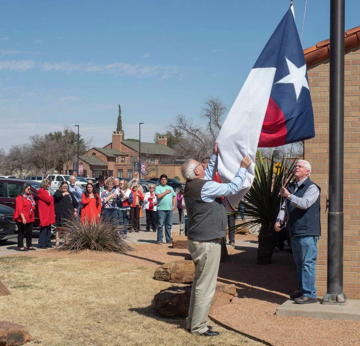 Brian McLaughlin and Pat McDaniel raise the ceremonial Texas Flag as Midlanders gather to celebrate and toast Texas Independence Day 03/02/2022 at the Haley Library. Tim Fischer/Reporter-Telegram
