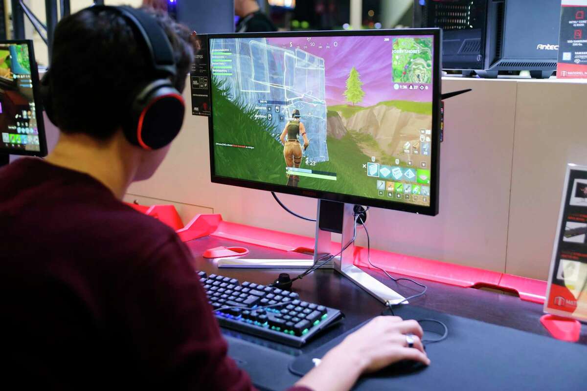 A gamer plays the video game “Fortnite Battle Royal” developed by Epic Games during a 2018 video game conference in Paris, France. Epic has continued an acquisition spree by buying Oakland-based Bandcamp.