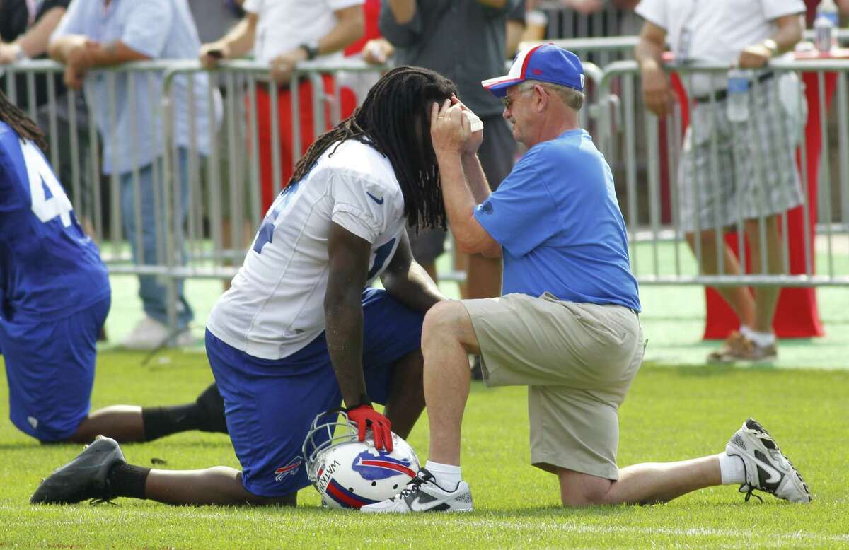 In this 2014 photo, Bud Carpenter, right, former head athletic trainer for the Buffalo Bills tends to wide receiver Sammy Watkins during their NFL football training camp in Pittsford, N.Y. Carpenter is lending his support to legislation to upgrade education requirements for athletic trainers in New York state. (AP Photo/Bill Wippert)