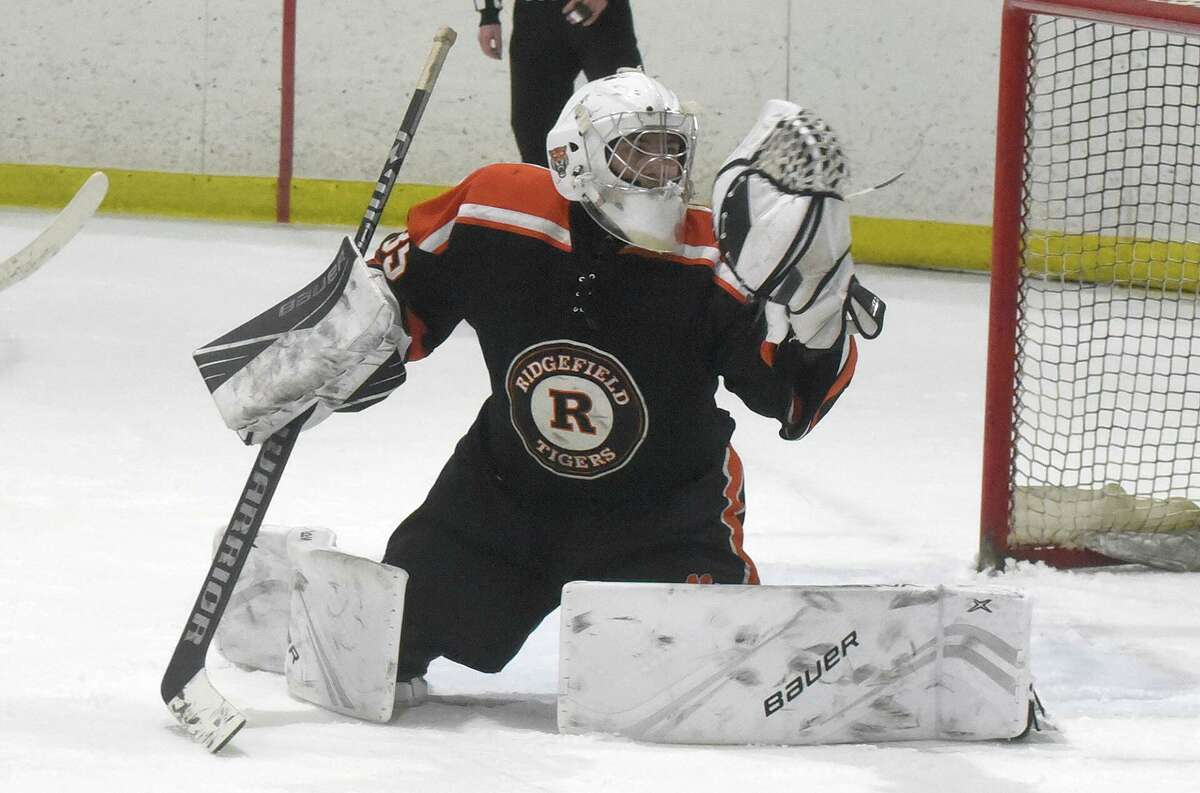 Ridgefield goalie Henry Ertl makes one of his 37 saves during the Tigers’ 1-0 win over Darien in the FCIAC boys ice hockey semifinals at the Darien Ice House on Wednesday, March 2, 2022.